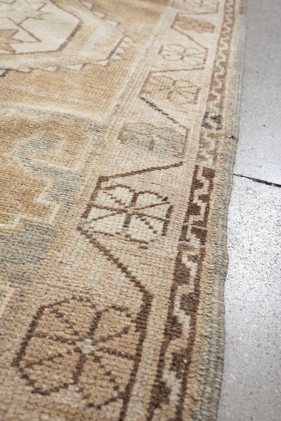 3' x 6' one-of-a-kind handmade vintage Kurd runner rug. Color palette: camel, ivory, pale blue, taupe, sand, light brown