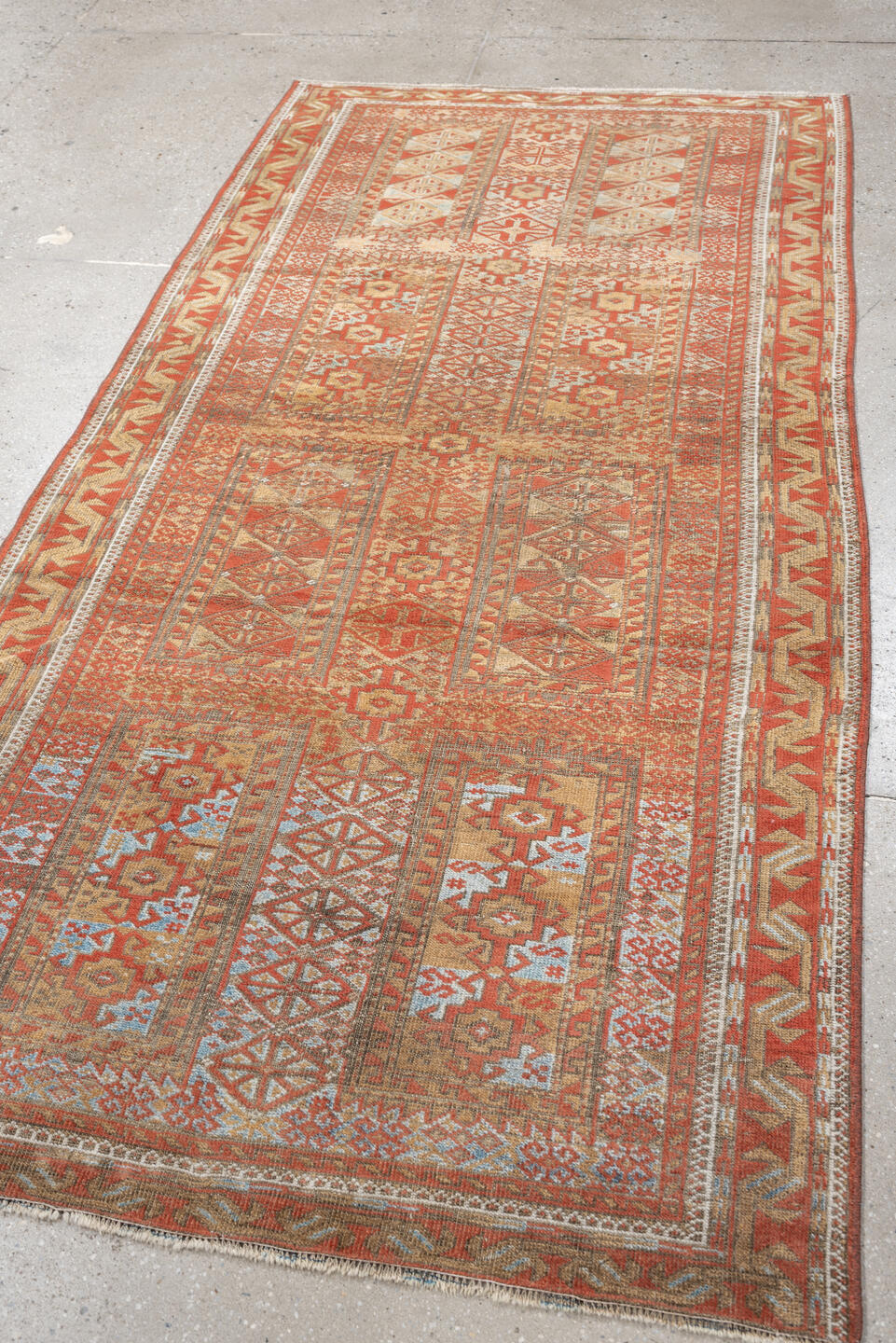 3' x 7' one-of-a-kind handmade antique Belouch rug. Color palette: terracotta, ivory, camel, taupe, rust, pale blue, brown