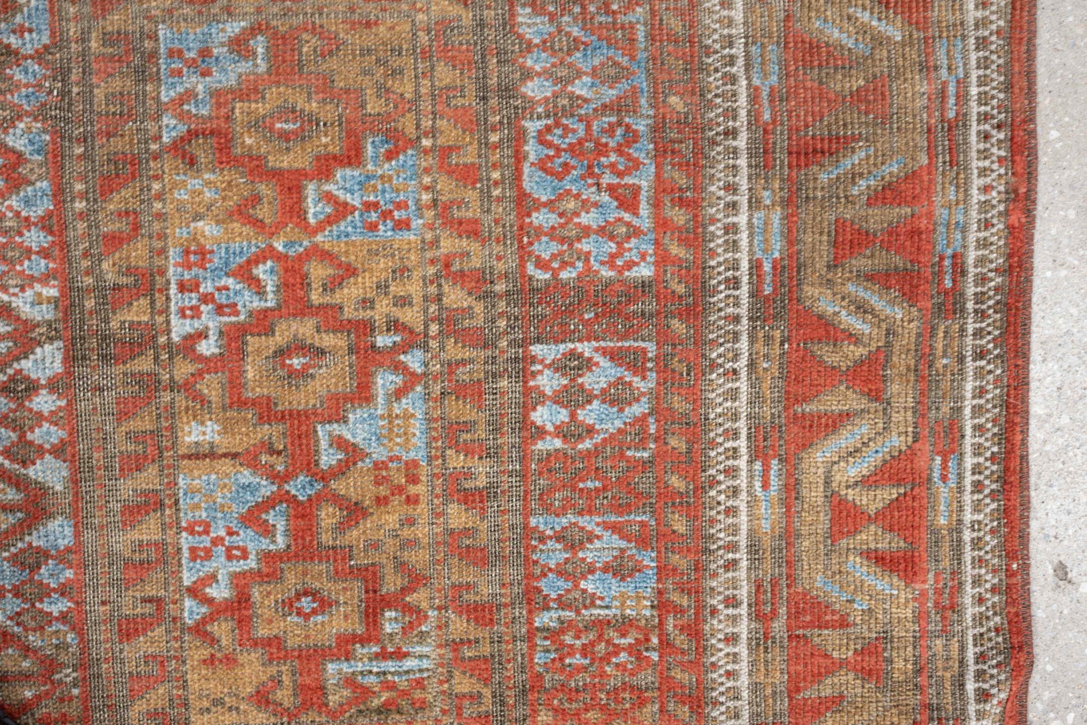 3' x 7' one-of-a-kind handmade antique Belouch rug. Color palette: terracotta, ivory, camel, taupe, rust, pale blue, brown
