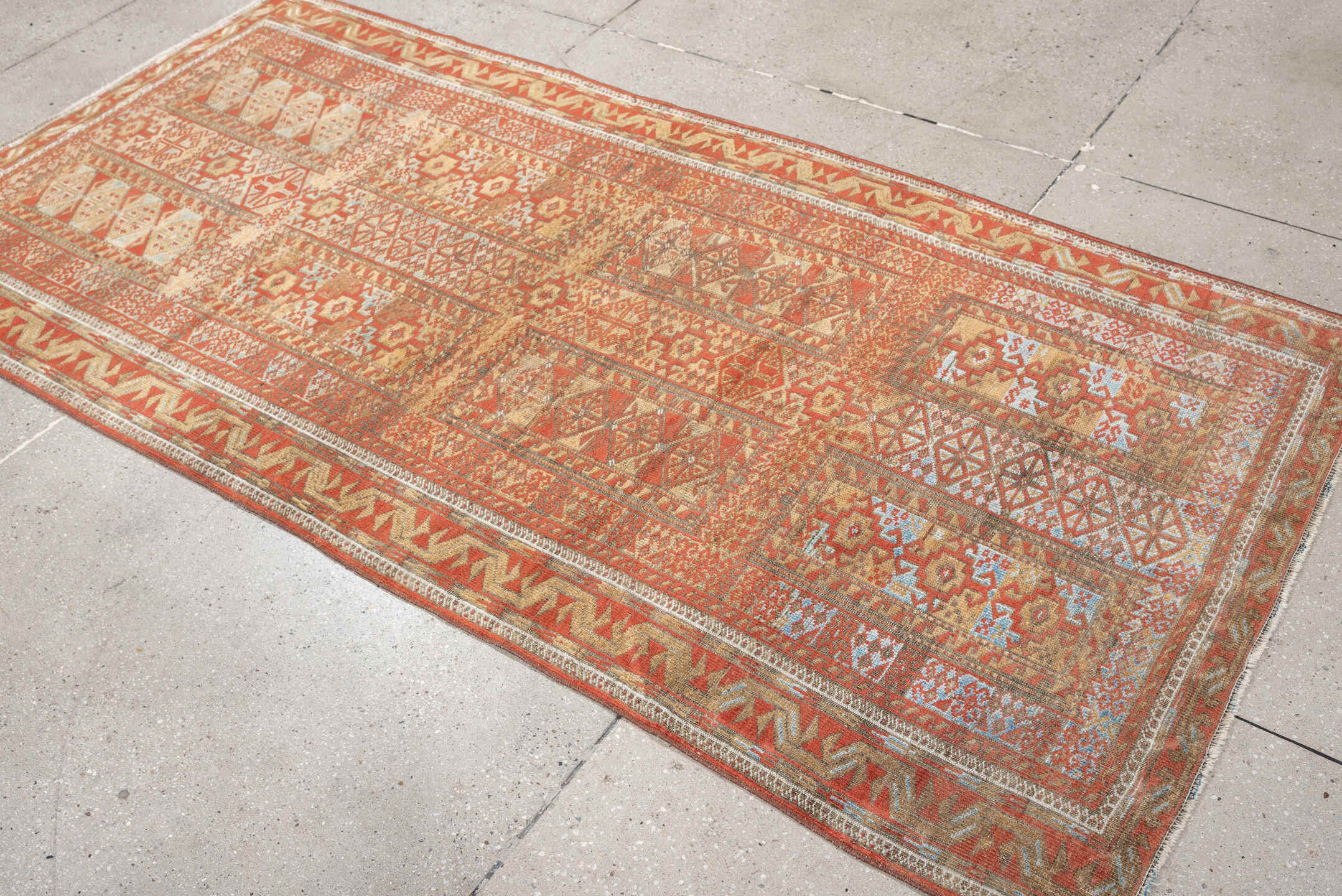 3' x 7' one-of-a-kind handmade antique Belouch rug. Color palette: terracotta, ivory, camel, taupe, rust, pale blue, brown