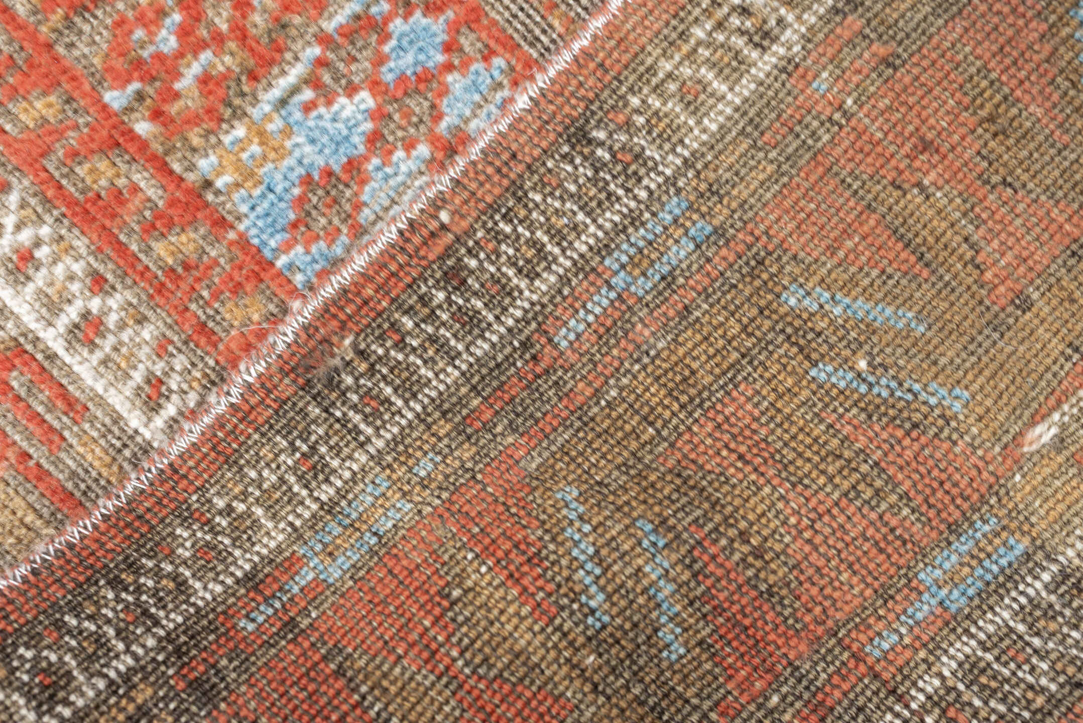 3' x 7' one-of-a-kind handmade antique Belouch rug. Color palette: terracotta, ivory, camel, taupe, rust, pale blue, brown
