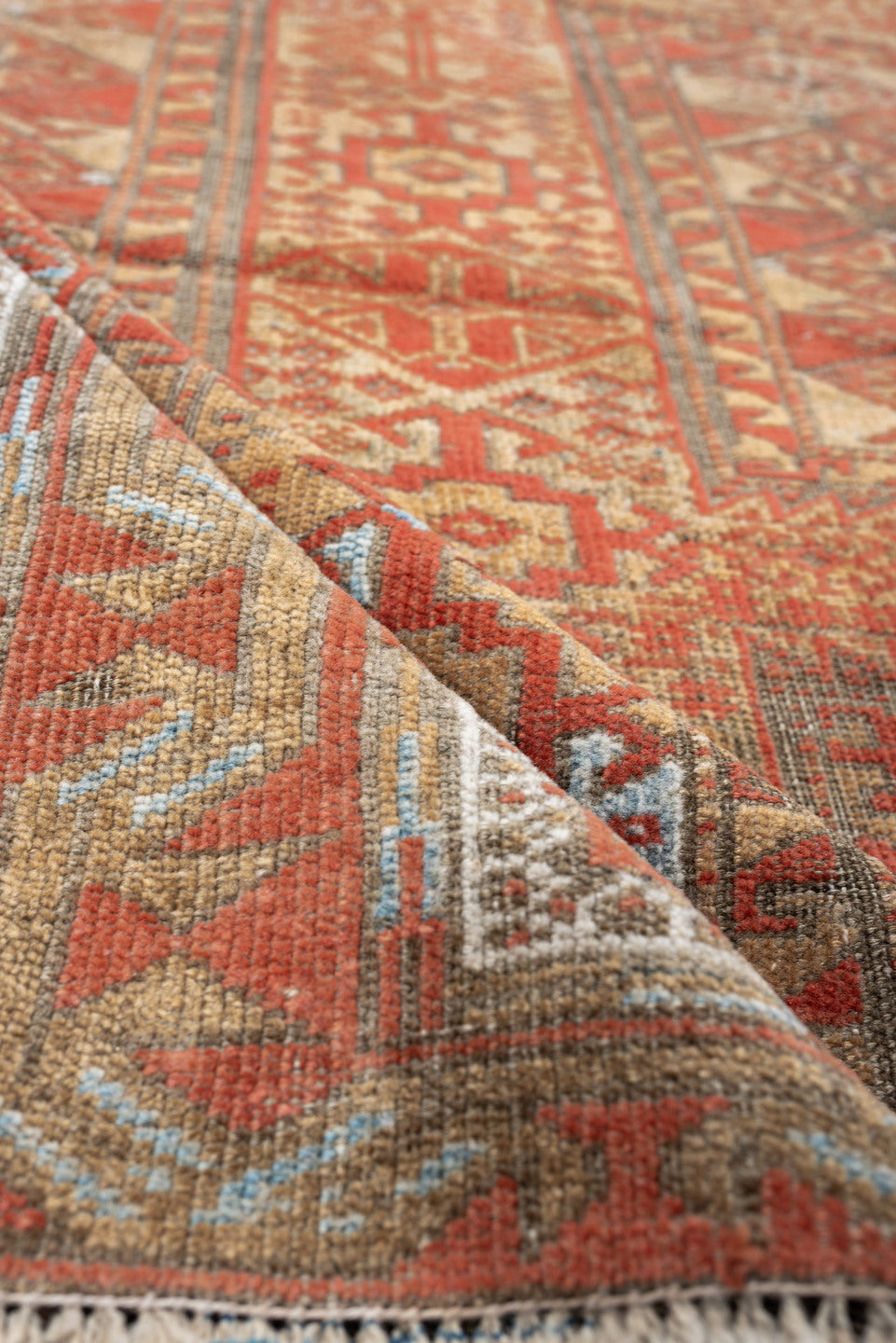 3' x 7' one-of-a-kind handmade antique Belouch rug. Color palette: terracotta, ivory, camel, taupe, rust, pale blue, brown