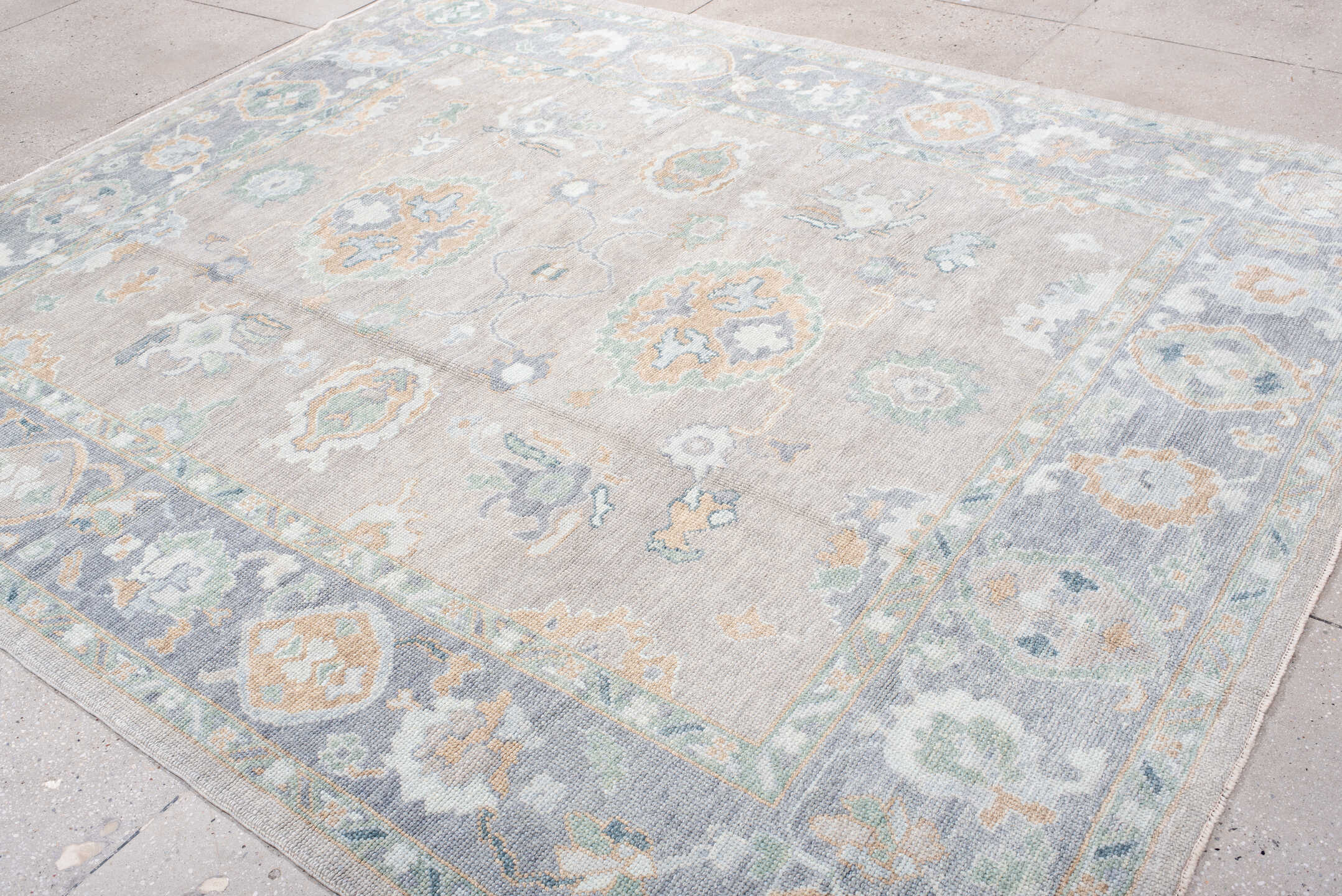 8' x 9' one-of-a-kind handmade vintage Oushak rug. Color palette: taupe, pale blue, ivory, sage, soft gold, peach, slate
