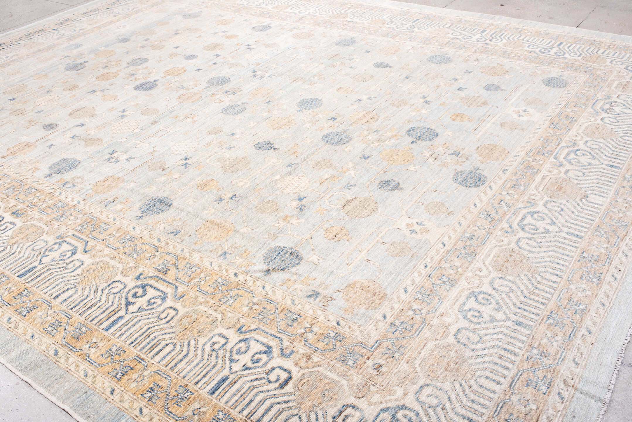 12' x 15' one-of-a-kind handmade vintage Khotan oversize rug. Color palette: ivory, pale blue, sand, beige, taupe
