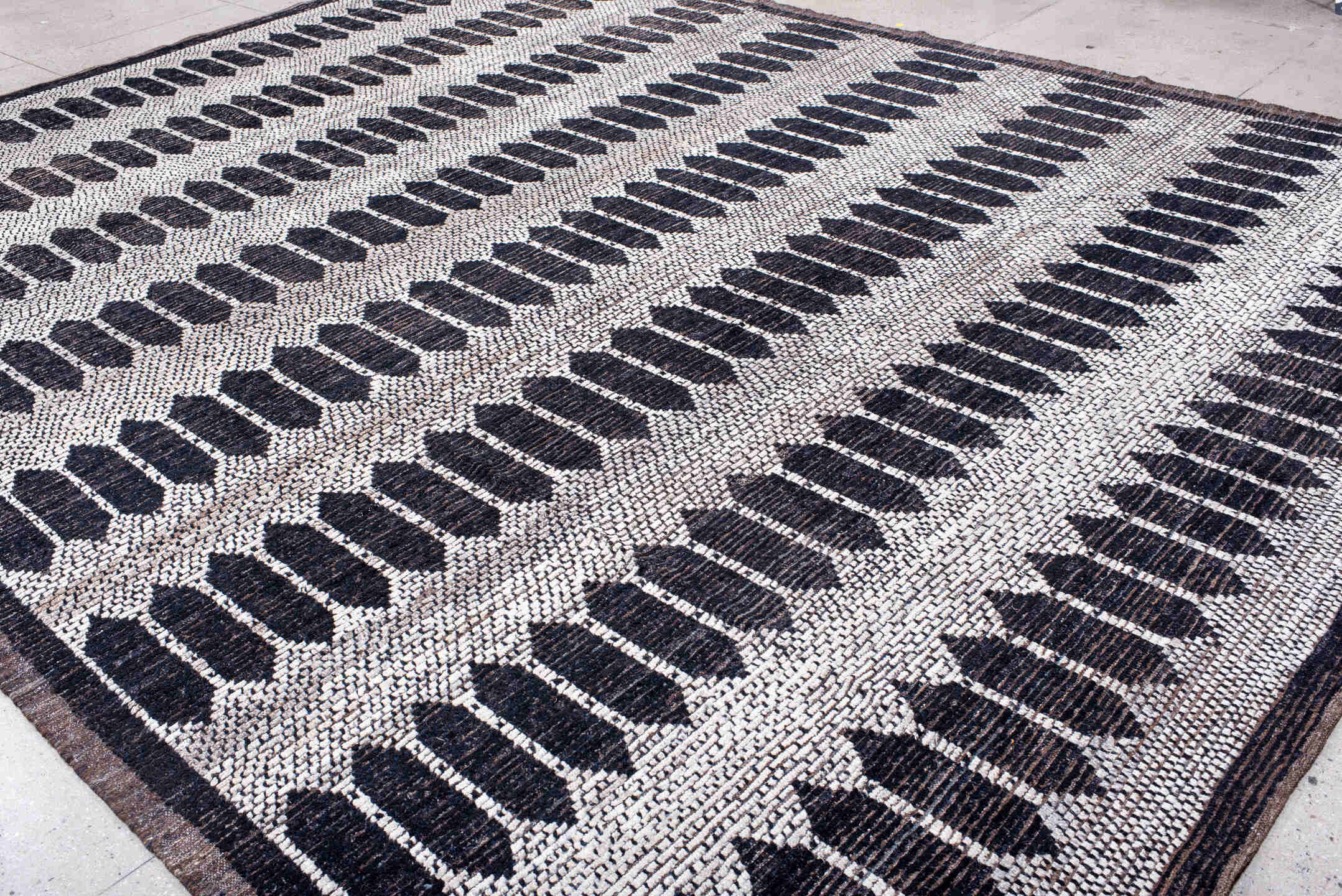 12' x 15' one-of-a-kind handmade vintage Tulu oversize rug. Color palette: ivory, charcoal, taupe, brown, gray, black, beige