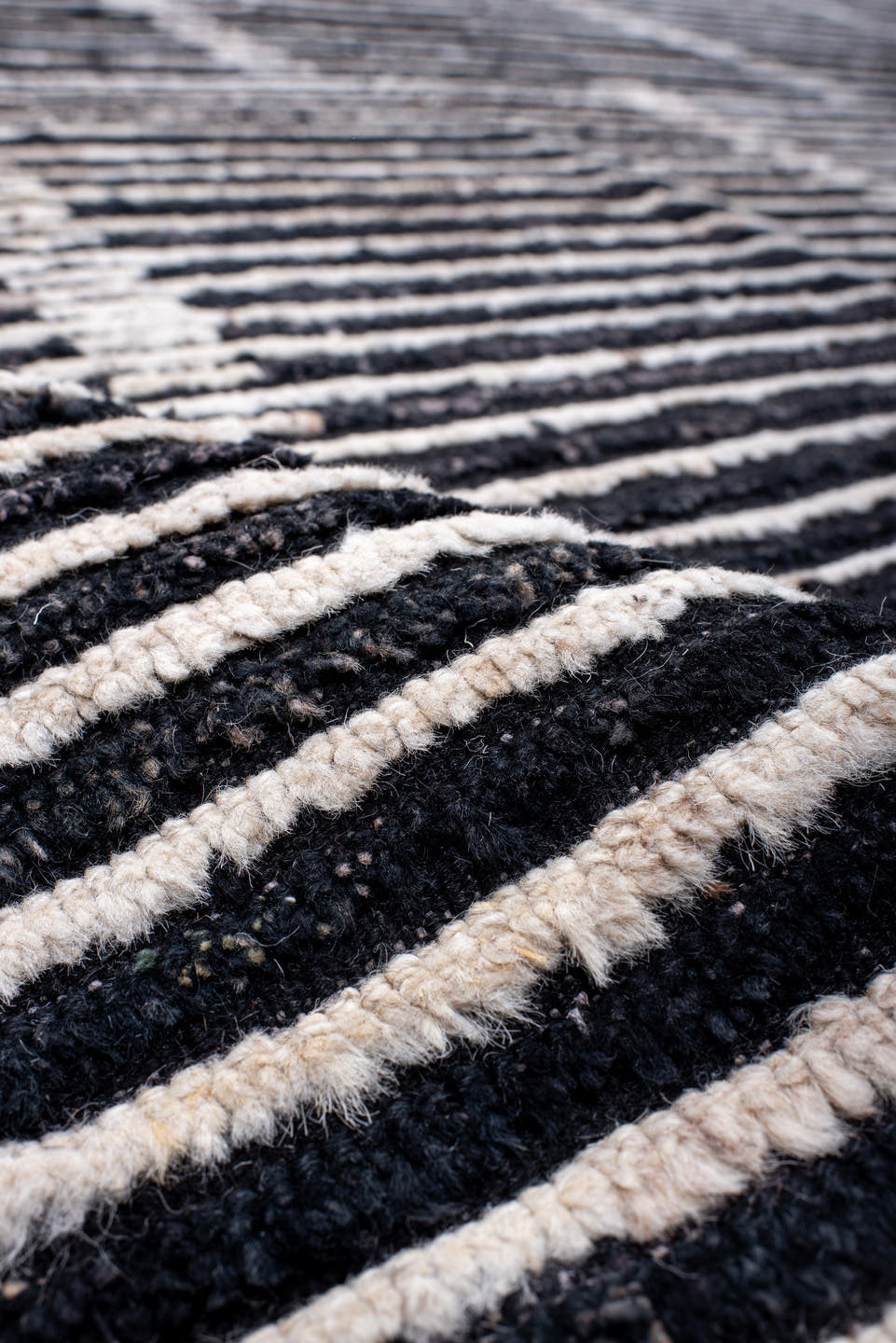 13' x 19' one-of-a-kind handmade vintage Tulu oversize rug. Color palette: charcoal, ivory, slate, black, gray