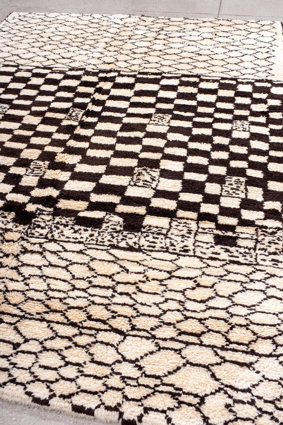 7' x 9' one-of-a-kind handmade vintage Moroccan rug. Color palette: ivory, brown, black, cream