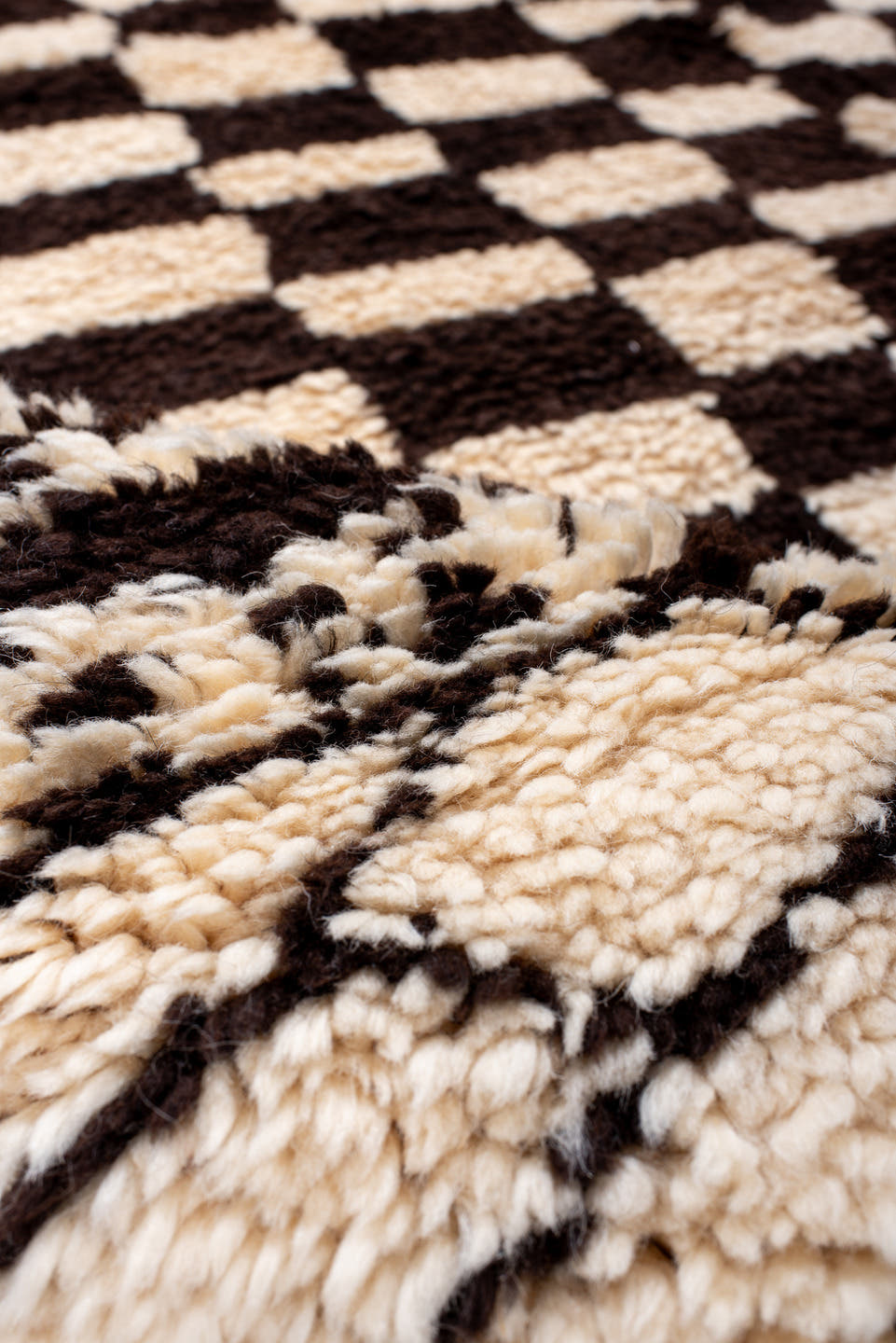 7' x 9' one-of-a-kind handmade vintage Moroccan rug. Color palette: ivory, brown, black, cream