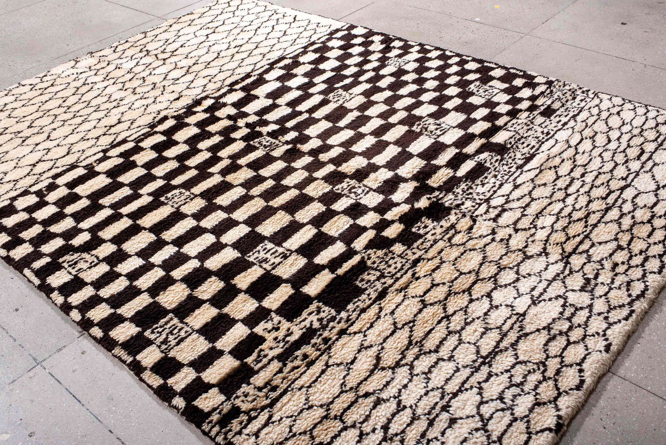 7' x 9' one-of-a-kind handmade vintage Moroccan rug. Color palette: ivory, brown, black, cream