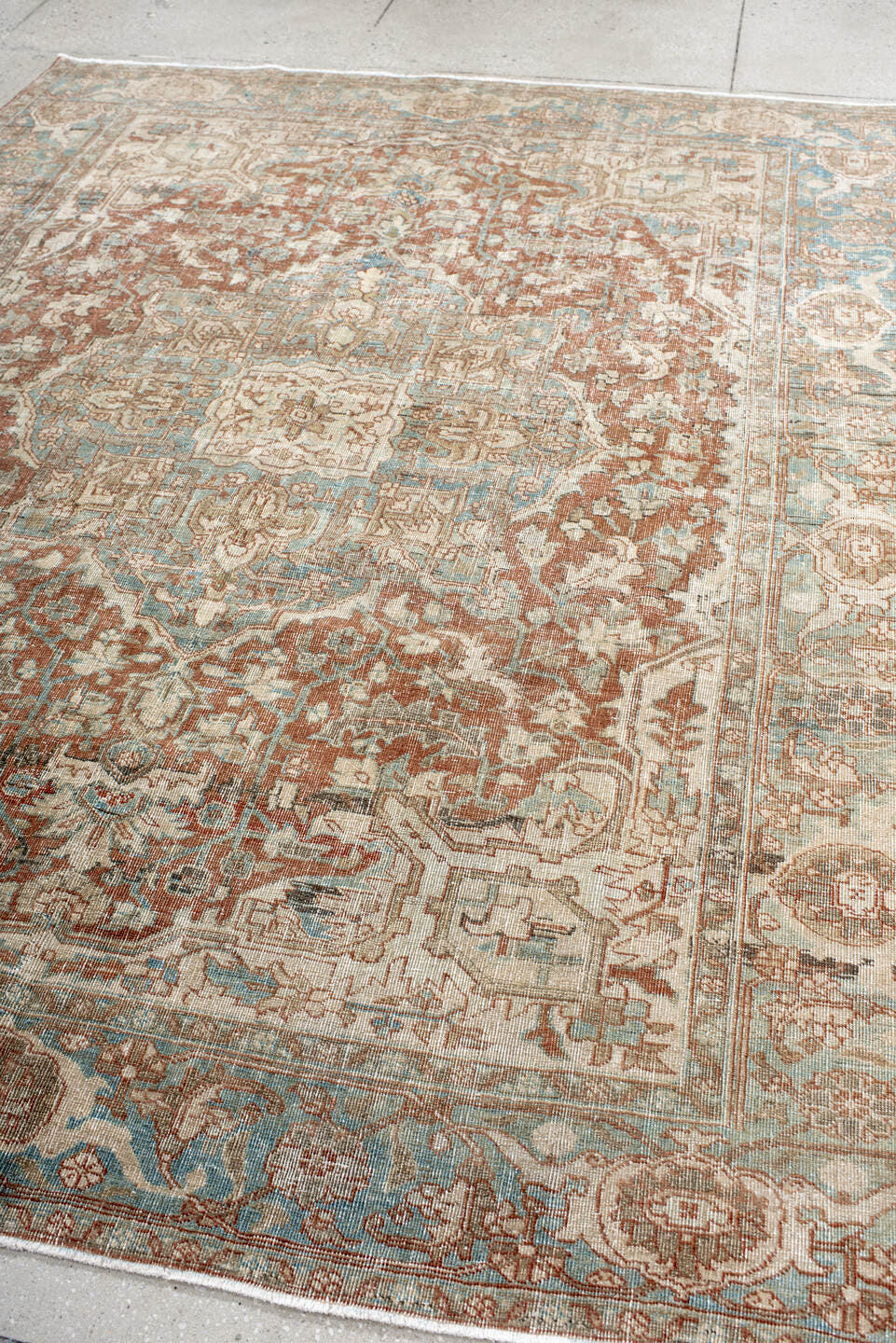 7' x 9' one-of-a-kind handmade antique Heriz rug. Color palette: ivory, sky blue, rust, taupe, camel, brown, light blue