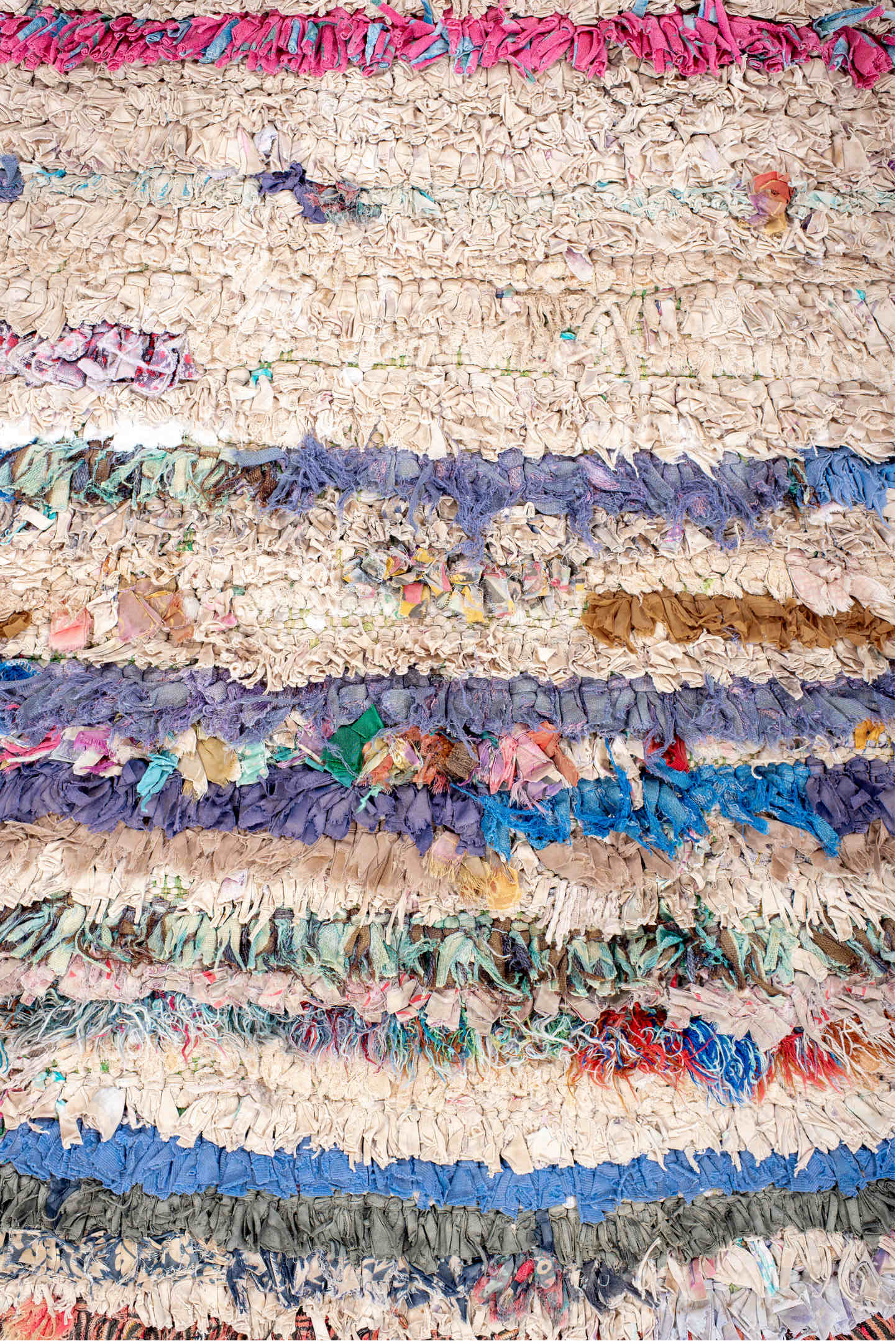 2' x 5' one-of-a-kind handmade vintage Rag Rug small size rug. Color palette: cream, pink, lavender, cobalt, charcoal, teal