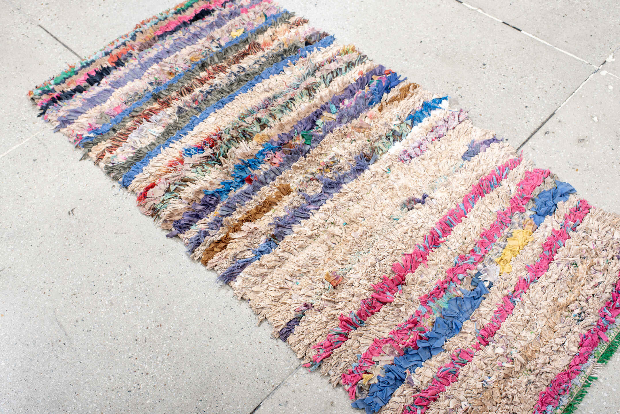 2' x 5' one-of-a-kind handmade vintage Rag Rug small size rug. Color palette: cream, pink, lavender, cobalt, charcoal, teal