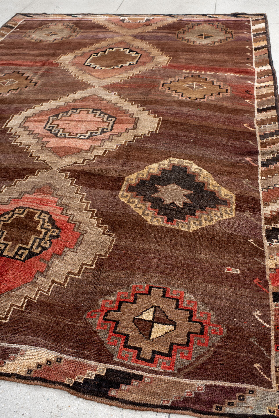 7' x 11' one-of-a-kind handmade antique Kars large size rug. Color palette: brown, taupe, rose, rust, ivory, charcoal