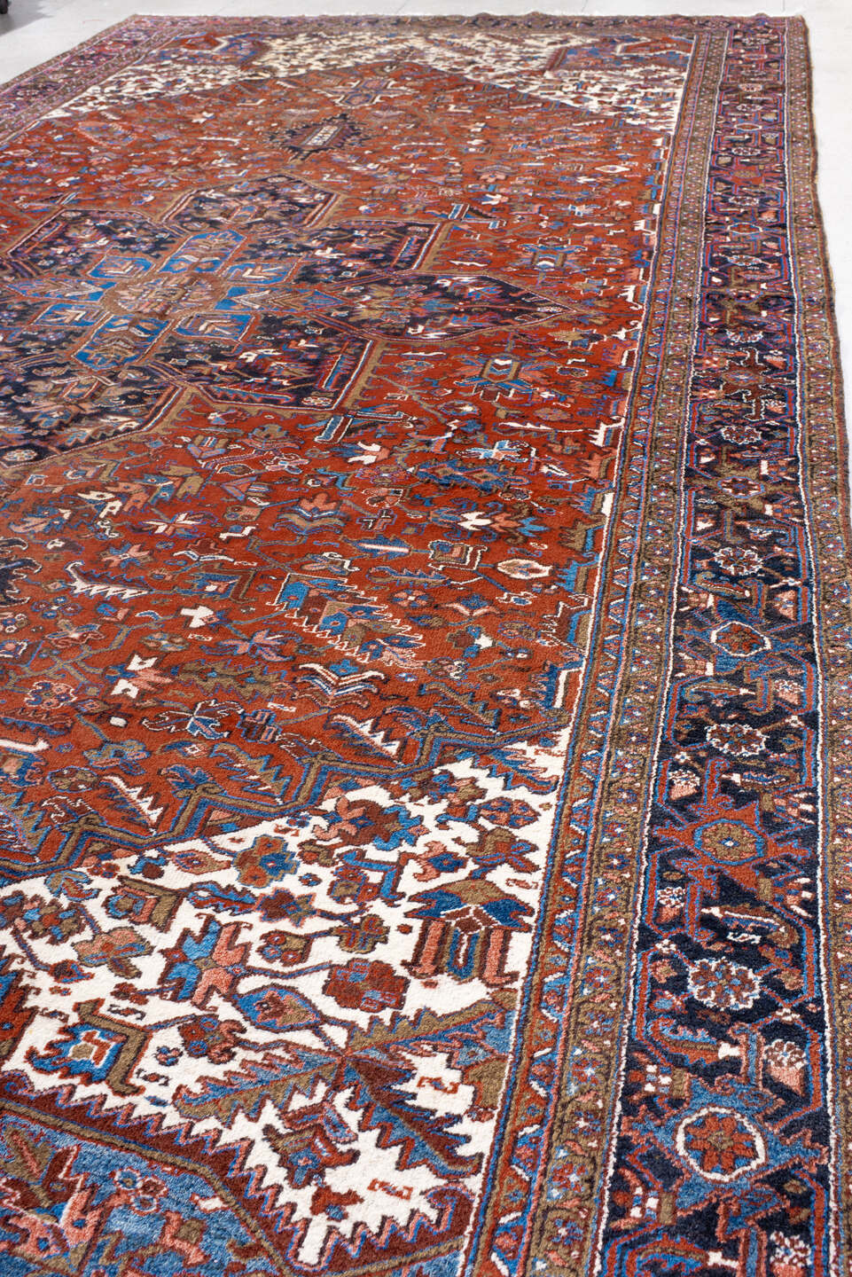 11' x 21' one-of-a-kind handmade antique Heriz oversize rug. Color palette: rust, ivory, navy, cobalt, terra cotta, charcoal