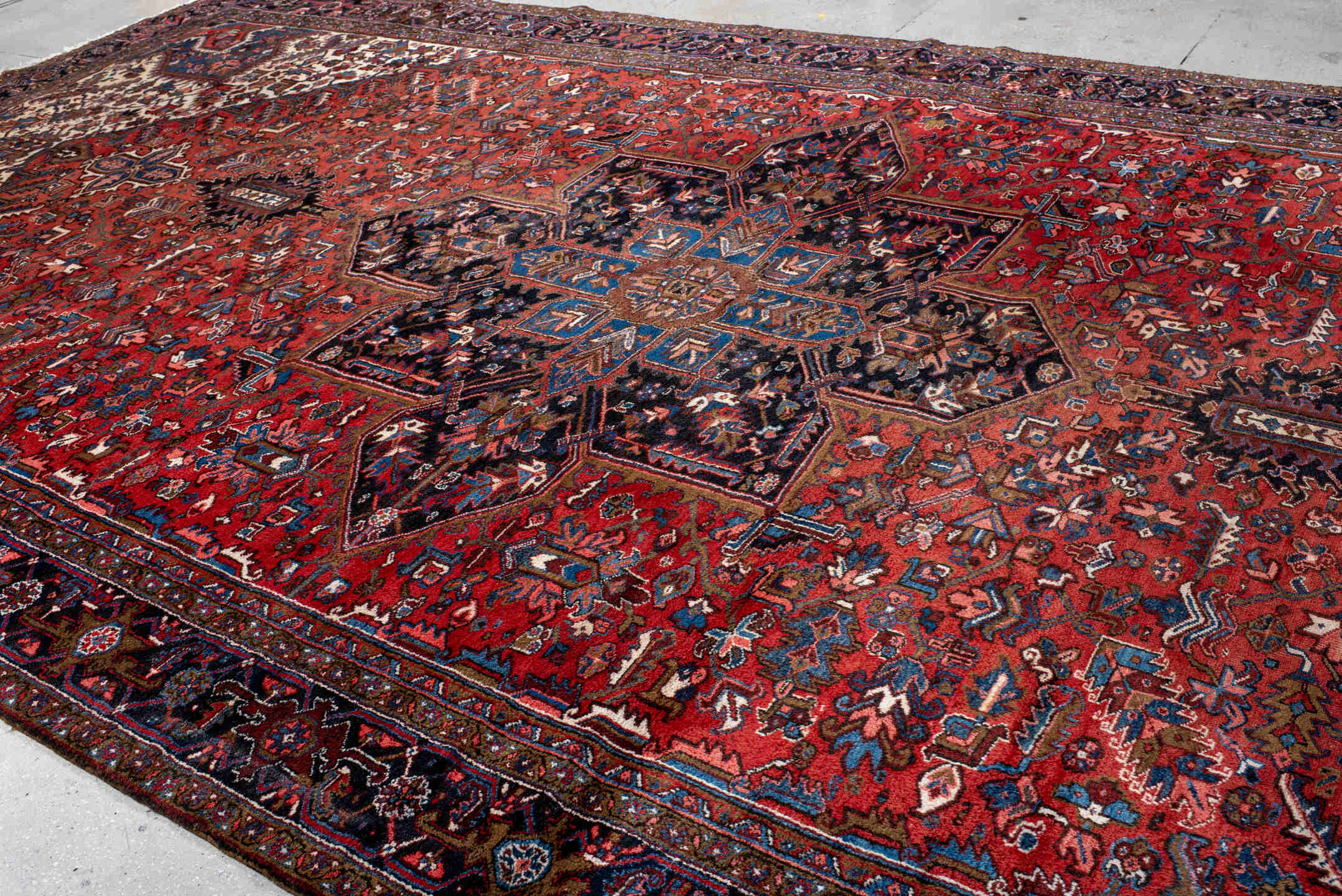 11' x 21' one-of-a-kind handmade antique Heriz oversize rug. Color palette: rust, ivory, navy, cobalt, terra cotta, charcoal