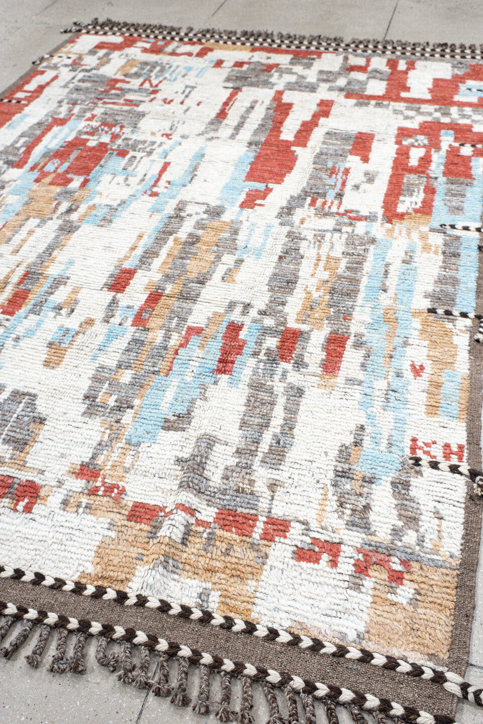 7' x 9' one-of-a-kind handmade vintage Tulu rug. Color palette: ivory, terra cotta, gray, pale aqua, camel, brown