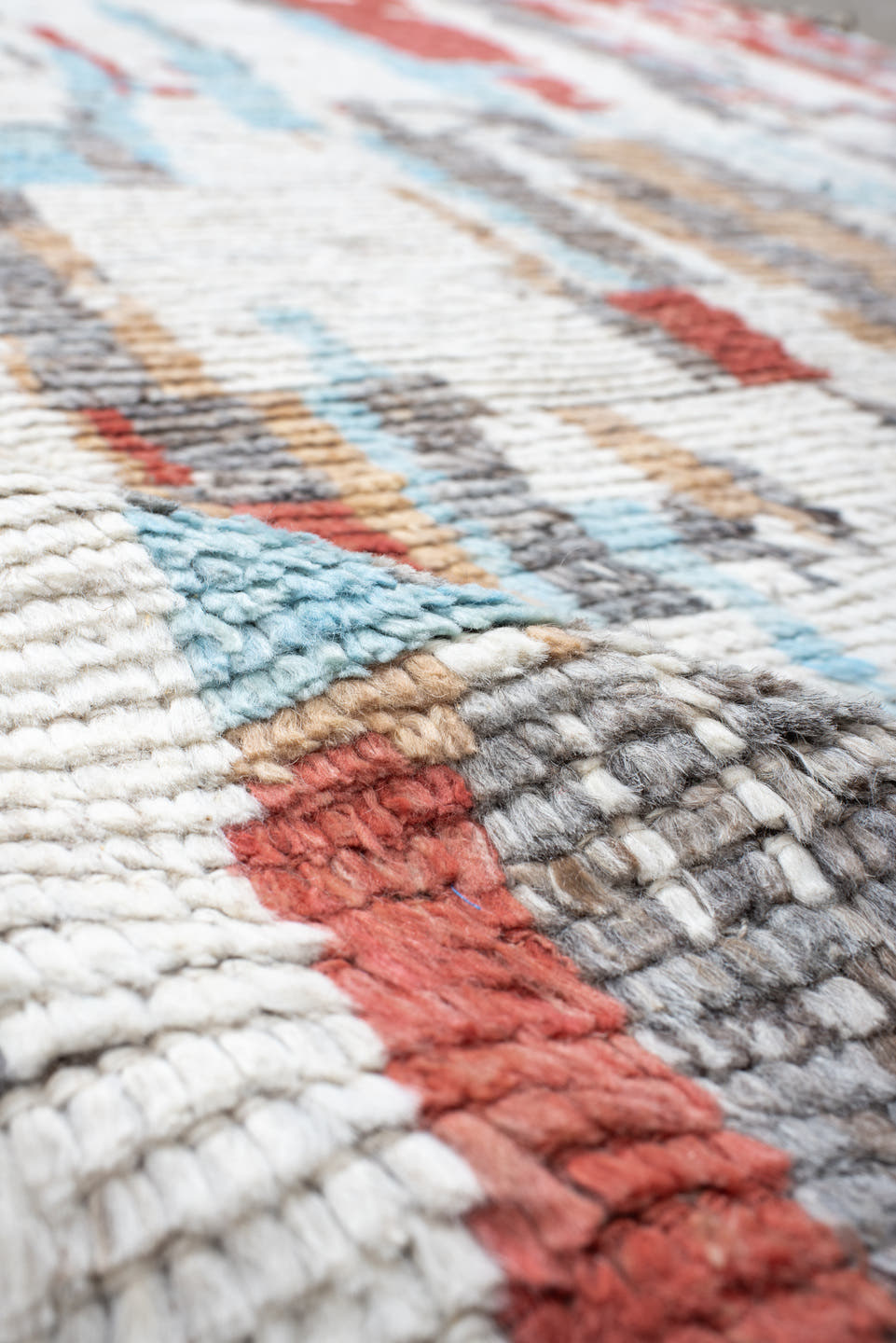 7' x 9' one-of-a-kind handmade vintage Tulu rug. Color palette: ivory, terra cotta, gray, pale aqua, camel, brown