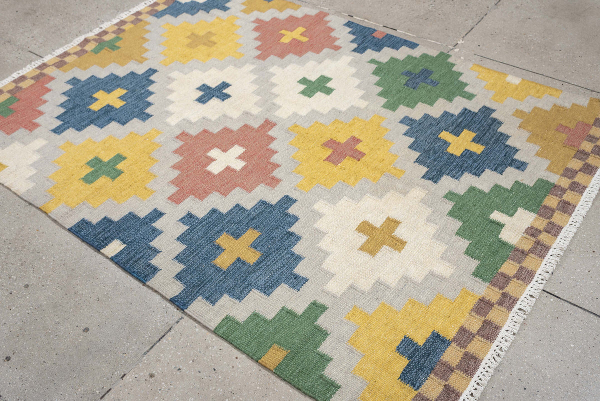 4' x 6' one-of-a-kind handmade antique Rollaken rug. Color palette: ivory, denim blue, yellow, sage green, dusty rose