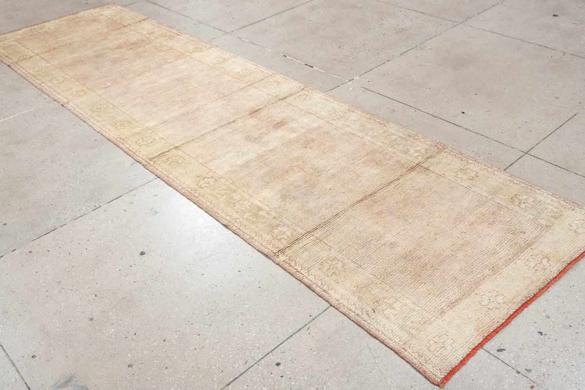 3' x 11' one-of-a-kind handmade antique Oushak runner rug. Color palette: ivory, blush, beige, soft sage, peach, pink