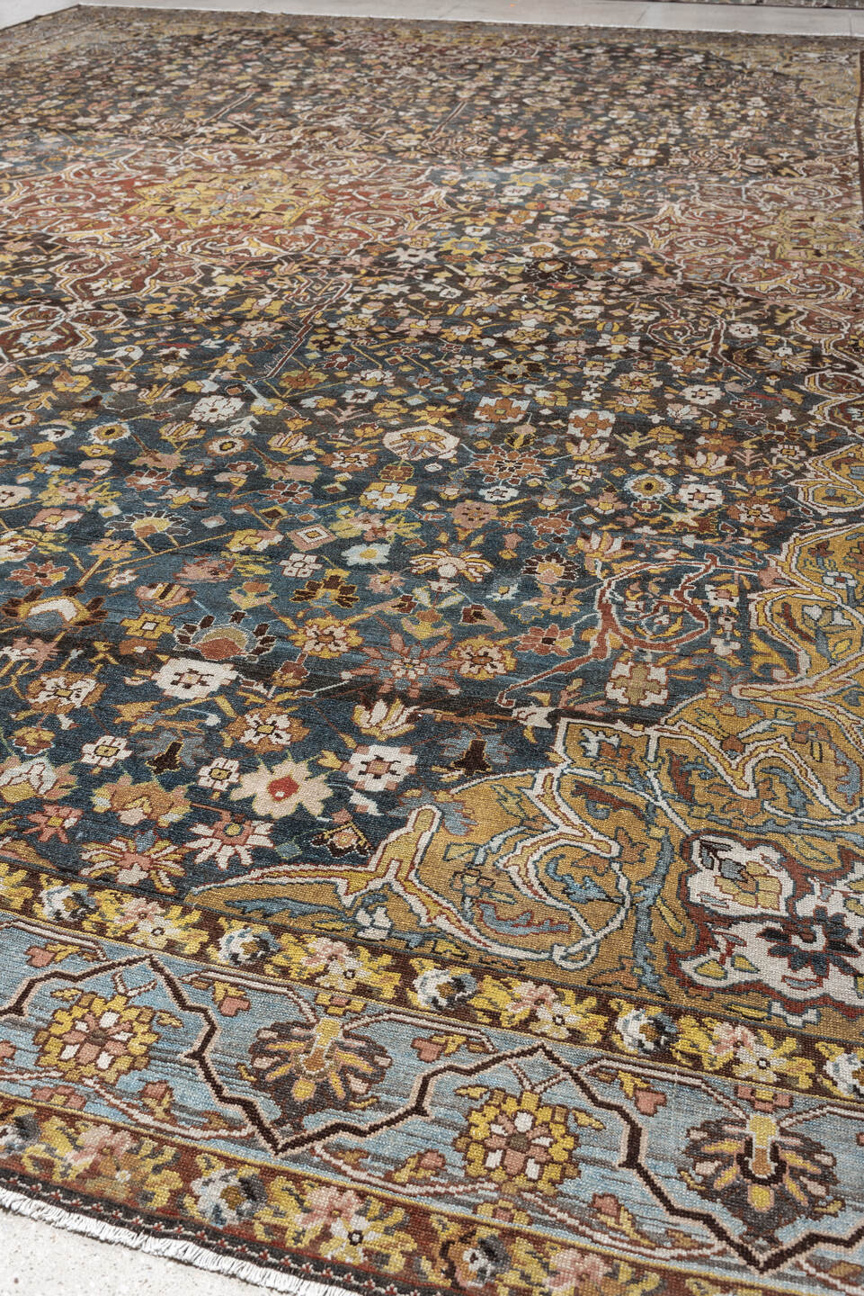 13' x 19' one-of-a-kind handmade antique Baktiary oversize rug. Color palette: charcoal, teal, rust, pale blue, ivory, gold