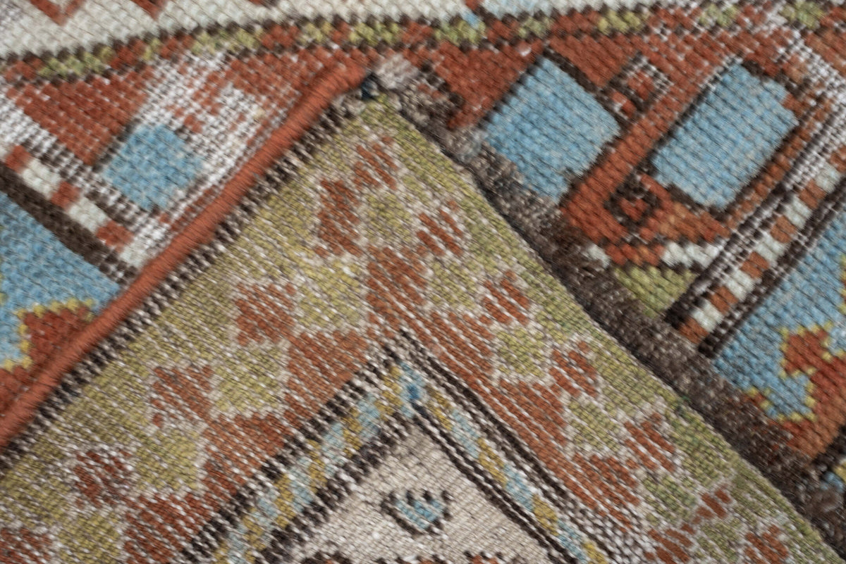 4' x 6' one-of-a-kind handmade antique Caucasian rug. Color palette: ivory, rust, sky blue, olive, camel, taupe, brown