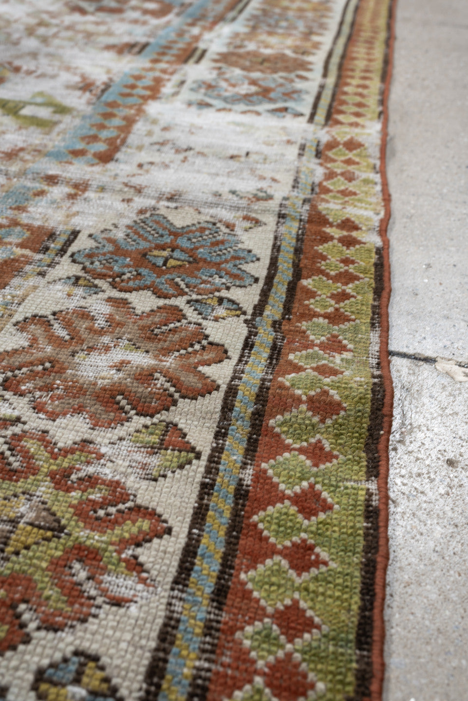 4' x 6' one-of-a-kind handmade antique Caucasian rug. Color palette: ivory, rust, sky blue, olive, camel, taupe, brown