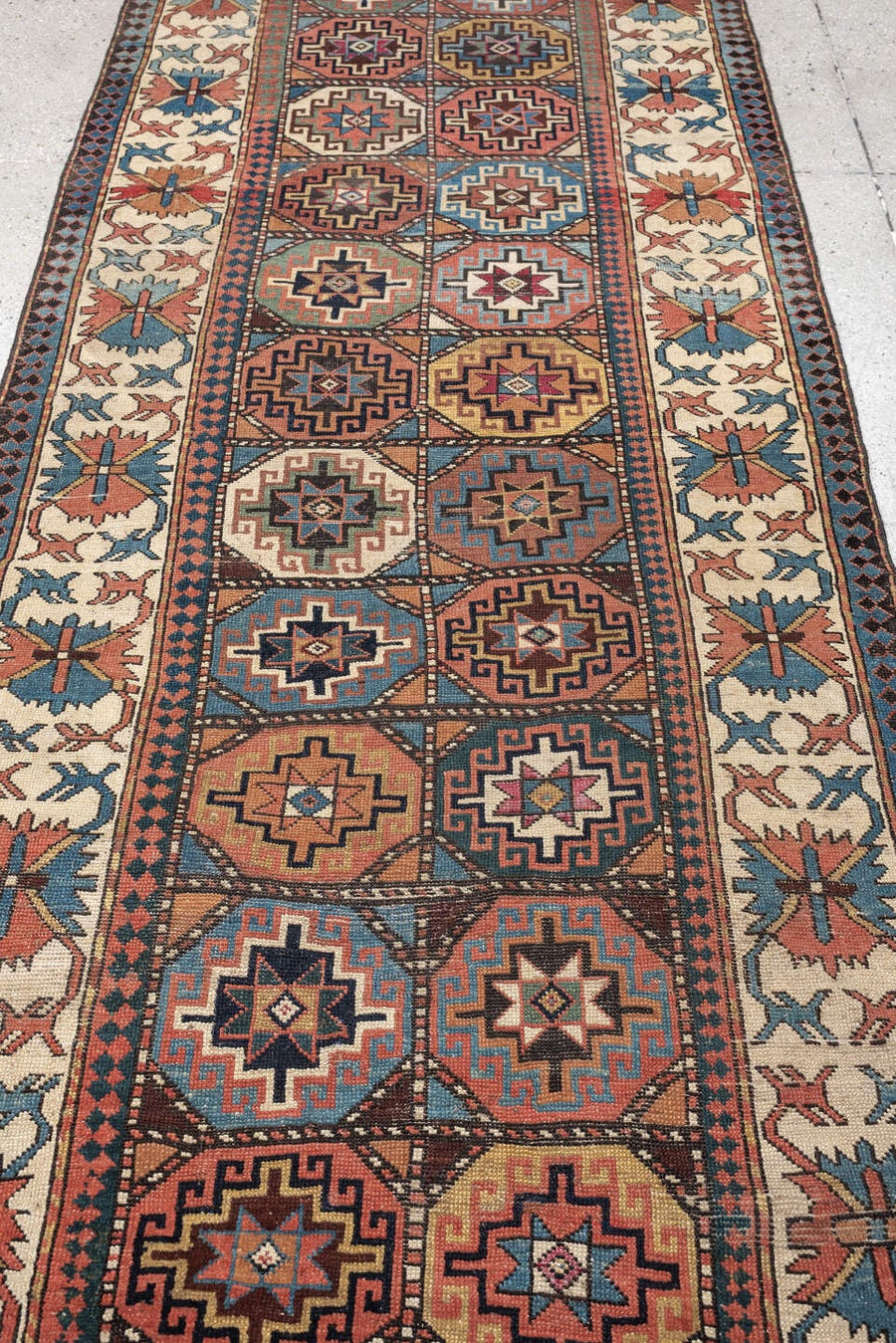 3' x 13' one-of-a-kind handmade antique Caucasian runner rug. Color palette: indigo, ivory, rust, coral, teal, charcoal