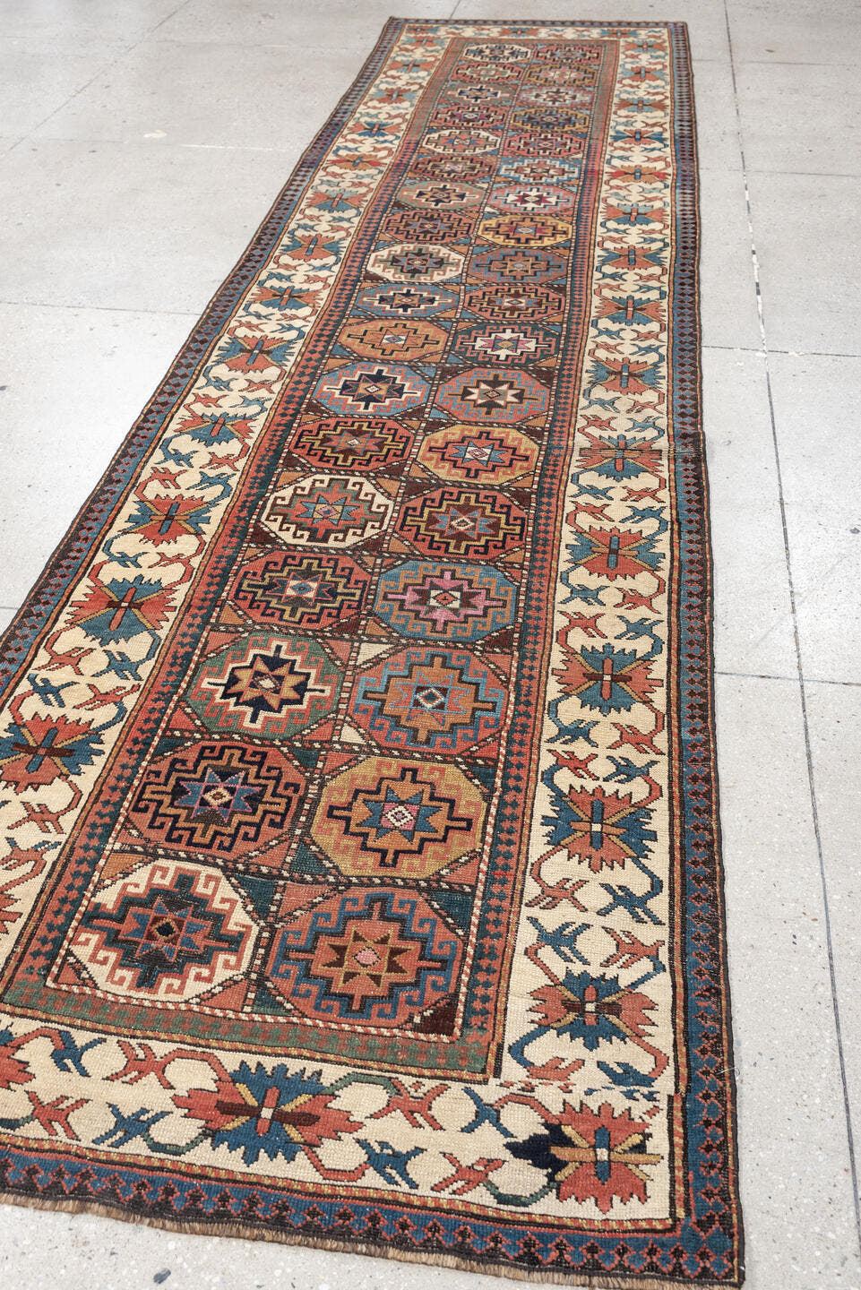 3' x 13' one-of-a-kind handmade antique Caucasian runner rug. Color palette: indigo, ivory, rust, coral, teal, charcoal