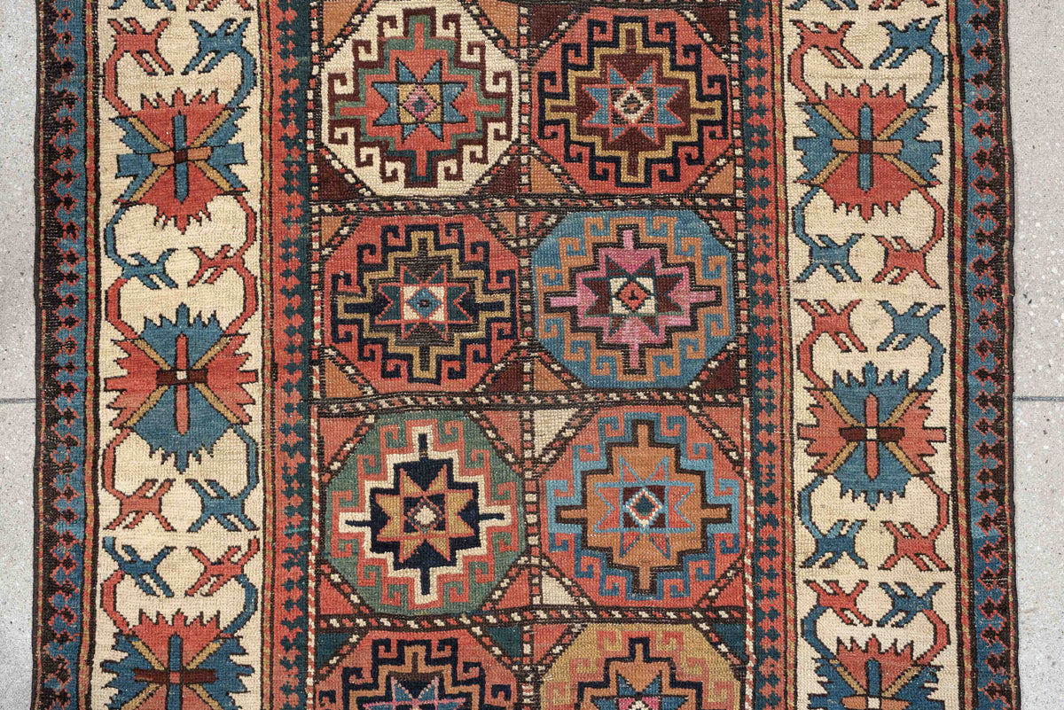 3' x 13' one-of-a-kind handmade antique Caucasian runner rug. Color palette: indigo, ivory, rust, coral, teal, charcoal