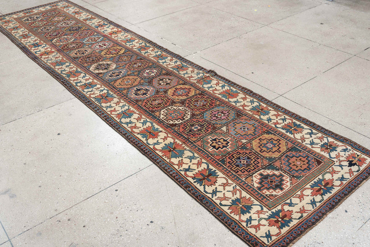 3' x 13' one-of-a-kind handmade antique Caucasian runner rug. Color palette: indigo, ivory, rust, coral, teal, charcoal