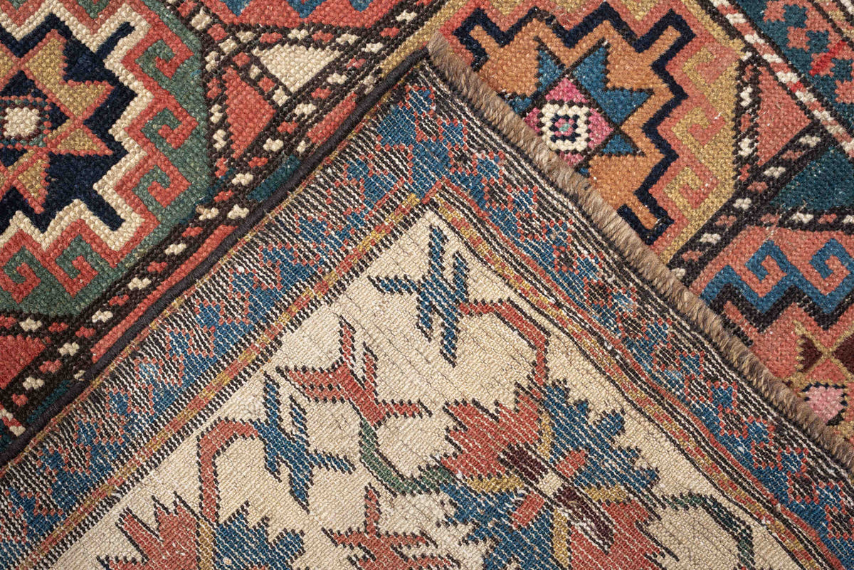 3' x 13' one-of-a-kind handmade antique Caucasian runner rug. Color palette: indigo, ivory, rust, coral, teal, charcoal