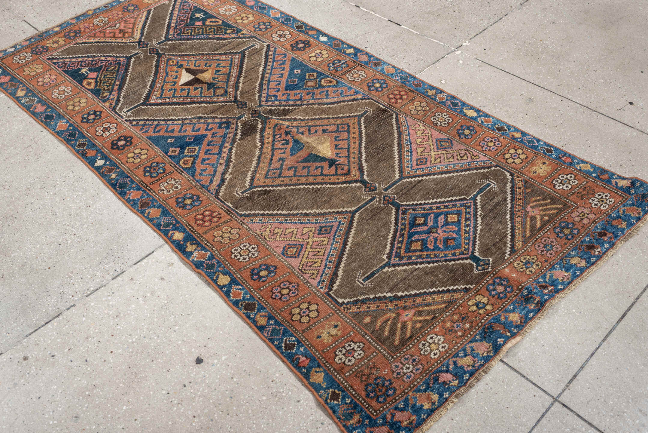3' x 6' one-of-a-kind handmade antique Kurd runner rug. Color palette: teal blue, camel, rose, ivory, brown, navy, salmon