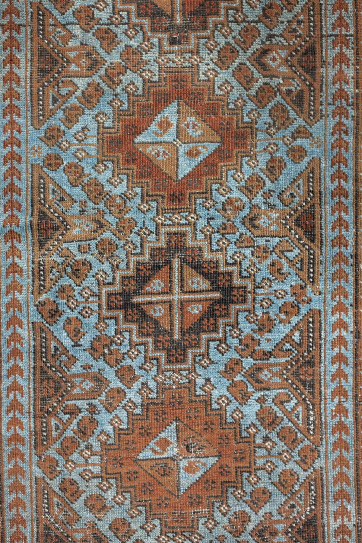 2' x 4' one-of-a-kind handmade antique Belouch small size rug. Color palette: rust, pale blue, camel, dark brown, ivory