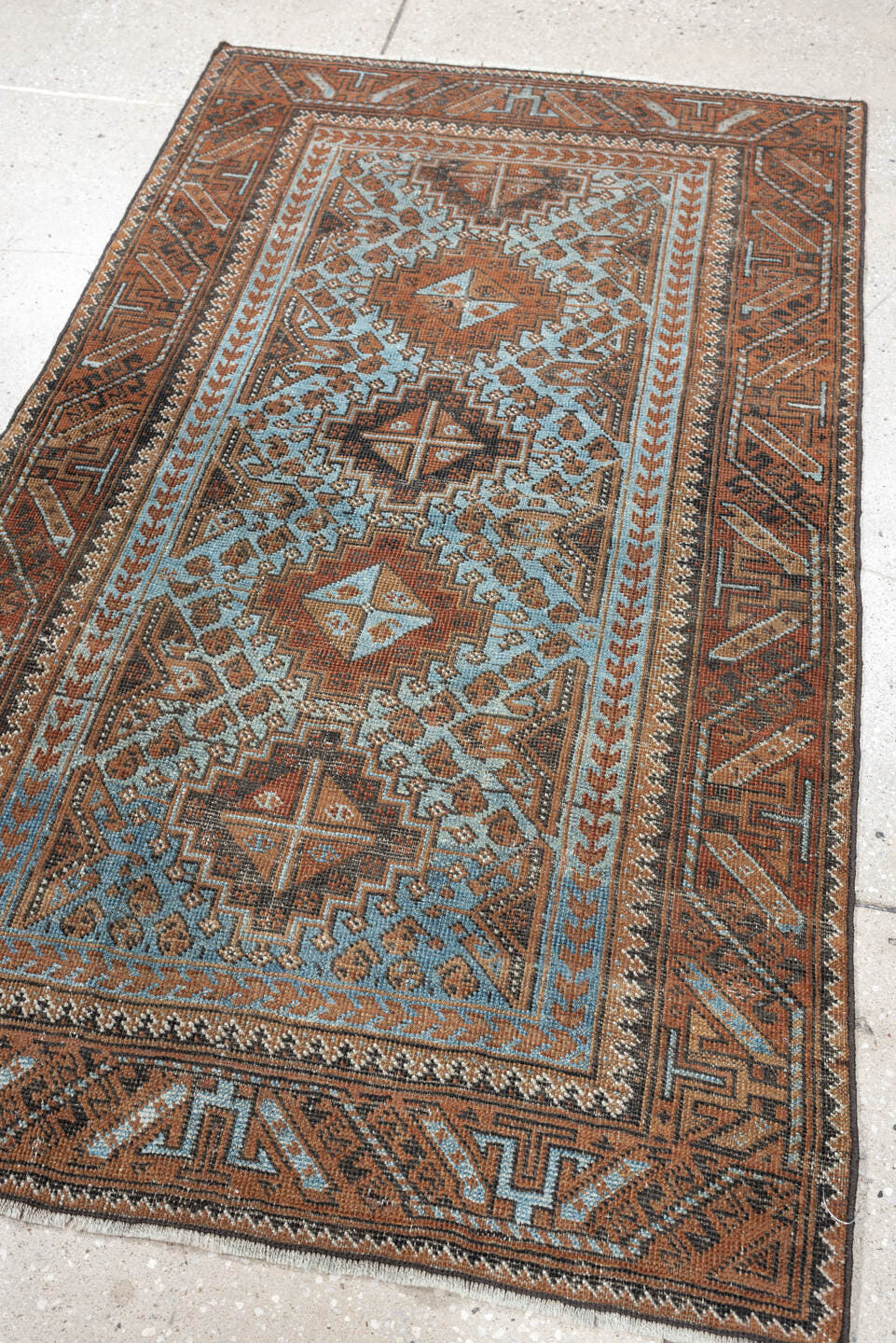 2' x 4' one-of-a-kind handmade antique Belouch small size rug. Color palette: rust, pale blue, camel, dark brown, ivory