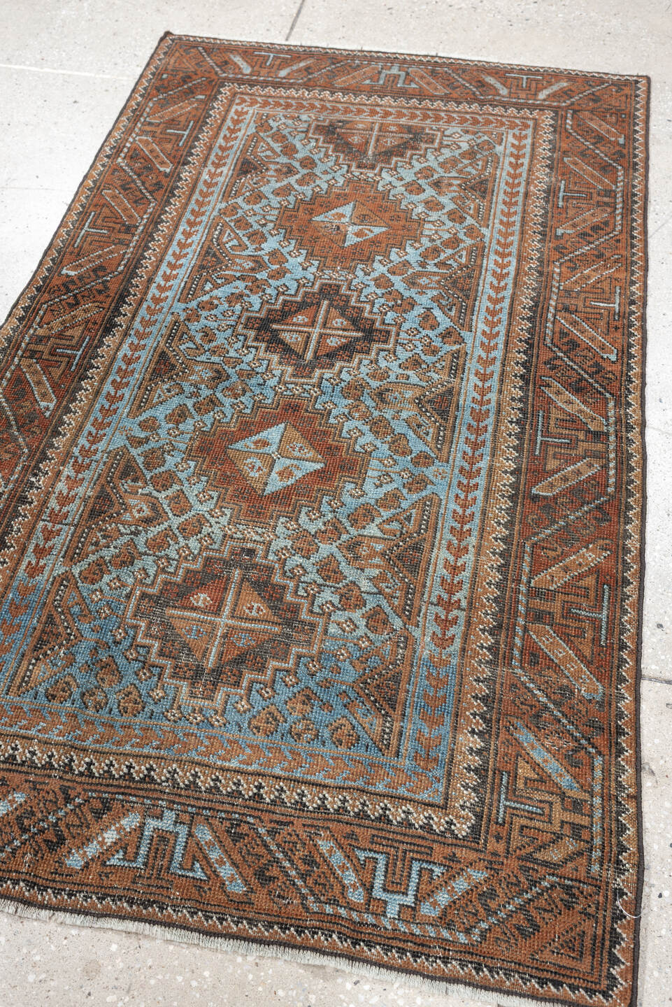 2' x 4' one-of-a-kind handmade antique Belouch small size rug. Color palette: rust, pale blue, camel, dark brown, ivory