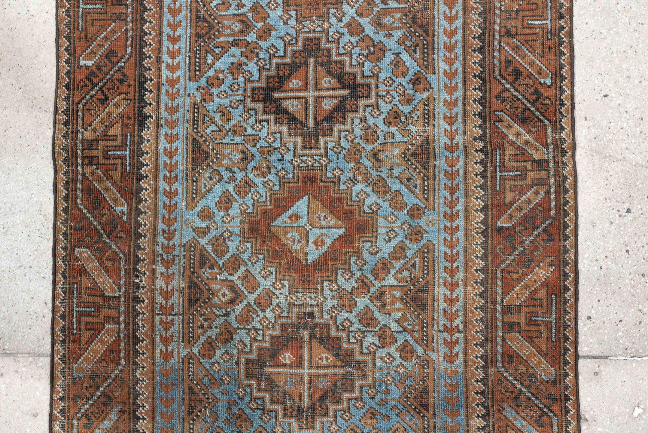 2' x 4' one-of-a-kind handmade antique Belouch small size rug. Color palette: rust, pale blue, camel, dark brown, ivory