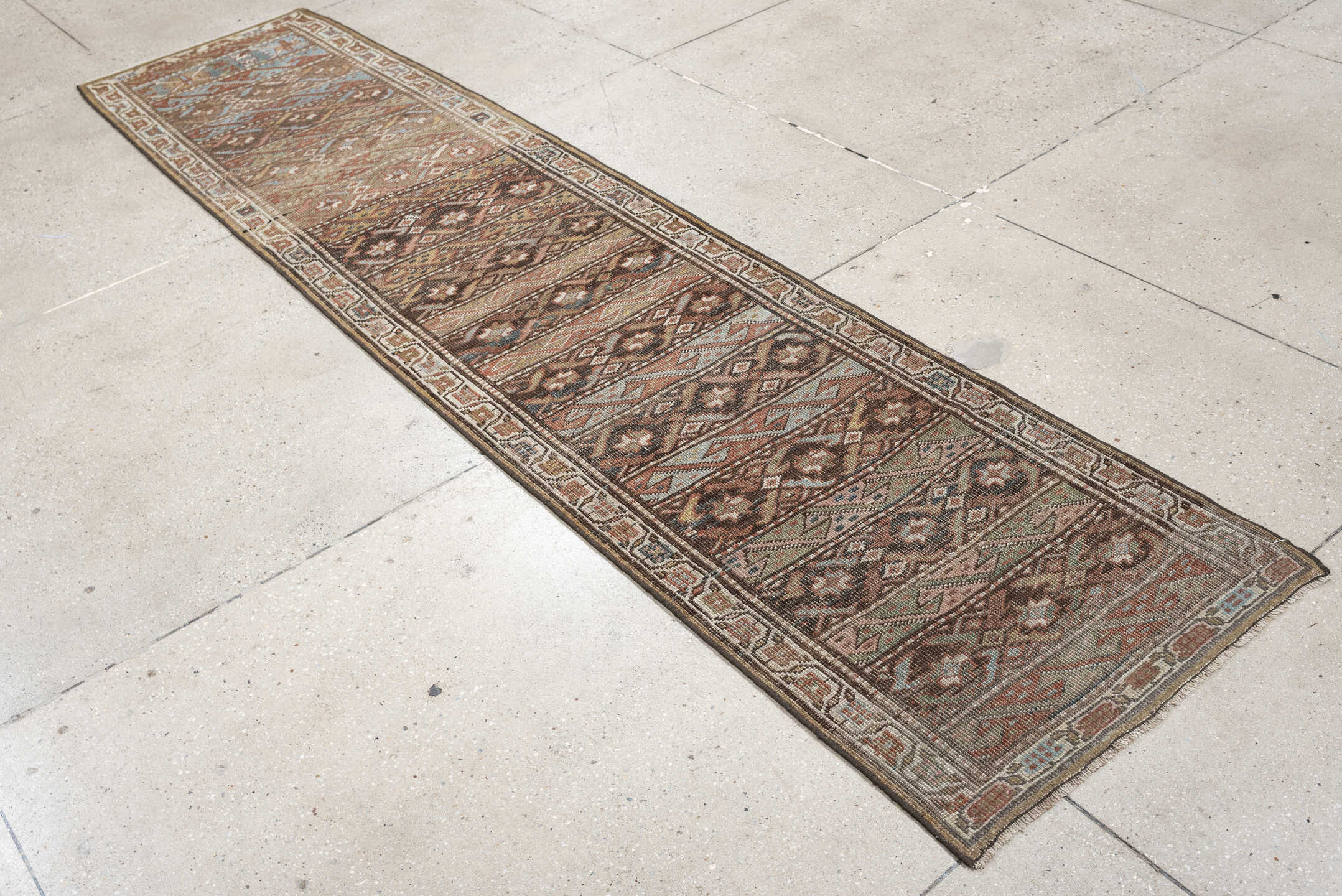2' x 9' one-of-a-kind handmade antique Bidjar runner rug. Color palette: brown, ivory, rust, sky blue, taupe, camel