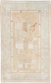 5' x 9' one-of-a-kind handmade antique Khotan medium size rug. Color palette: ivory, sand, celadon, beige, taupe, camel