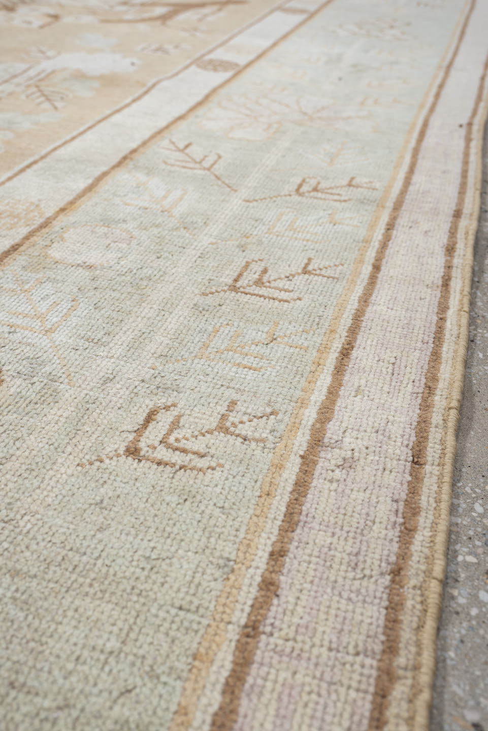 5' x 9' one-of-a-kind handmade antique Khotan medium size rug. Color palette: ivory, sand, celadon, beige, taupe, camel