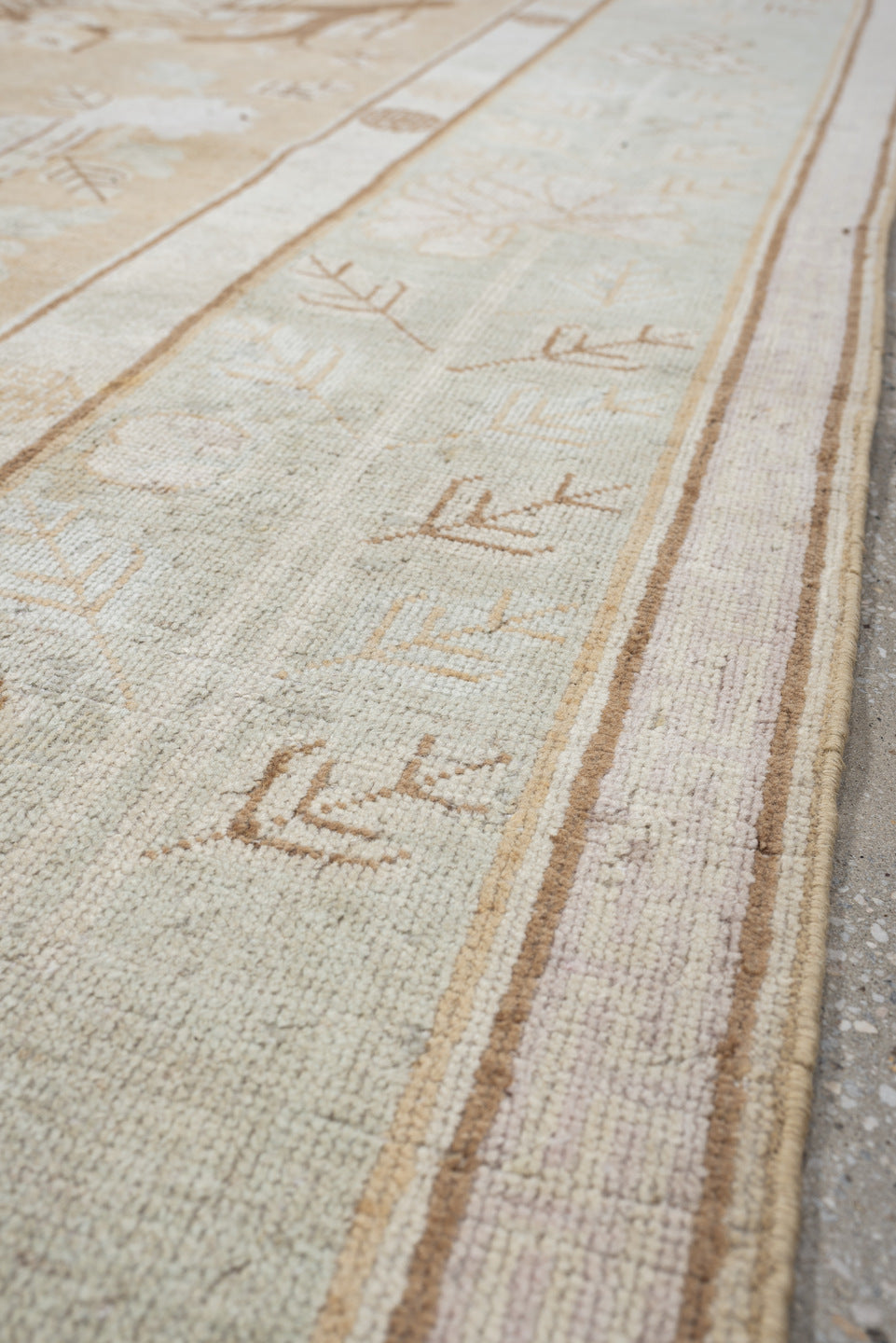 5' x 9' one-of-a-kind handmade antique Khotan medium size rug. Color palette: ivory, sand, celadon, beige, taupe, camel