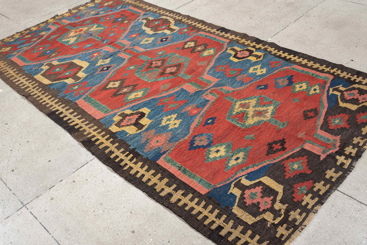 4' x 9' one-of-a-kind handmade antique Kilim medium size rug. Color palette: rust, blue, ivory, charcoal, rose, olive, teal