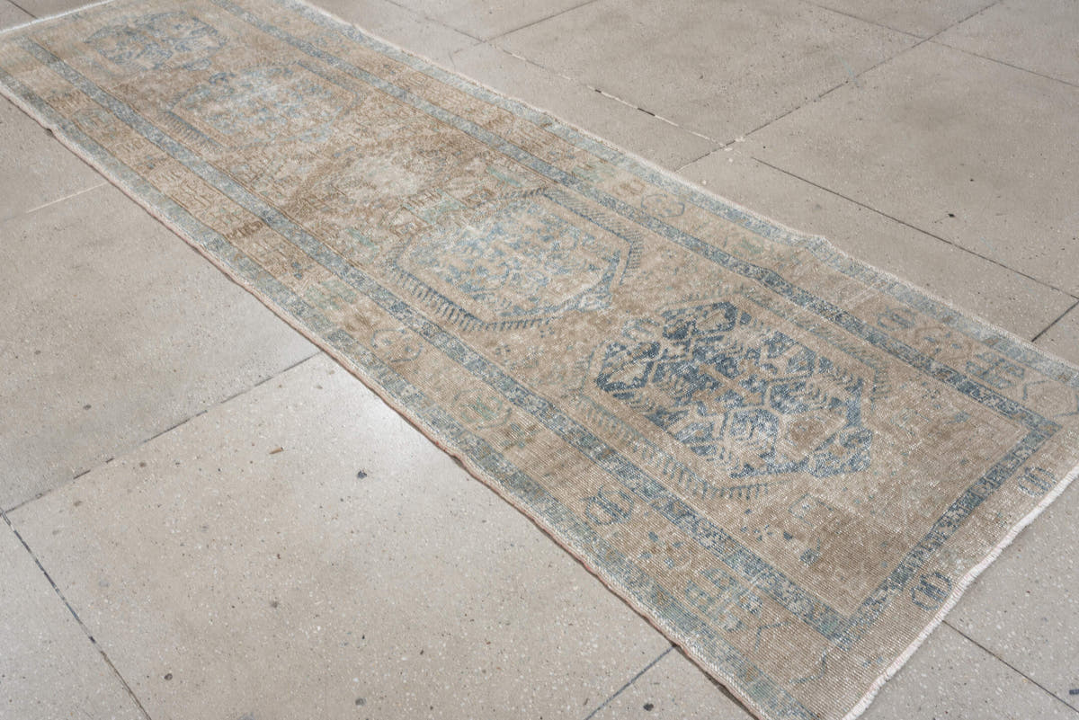 3' x 11' one-of-a-kind handmade antique Heriz runner rug. Color palette: ivory, pale blue, beige, taupe, camel, light blue
