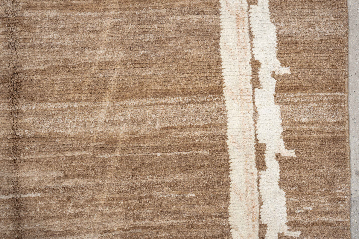 7' x 9' one-of-a-kind handmade vintage Tibetan rug. Color palette: camel, ivory, taupe, beige, cream, gray