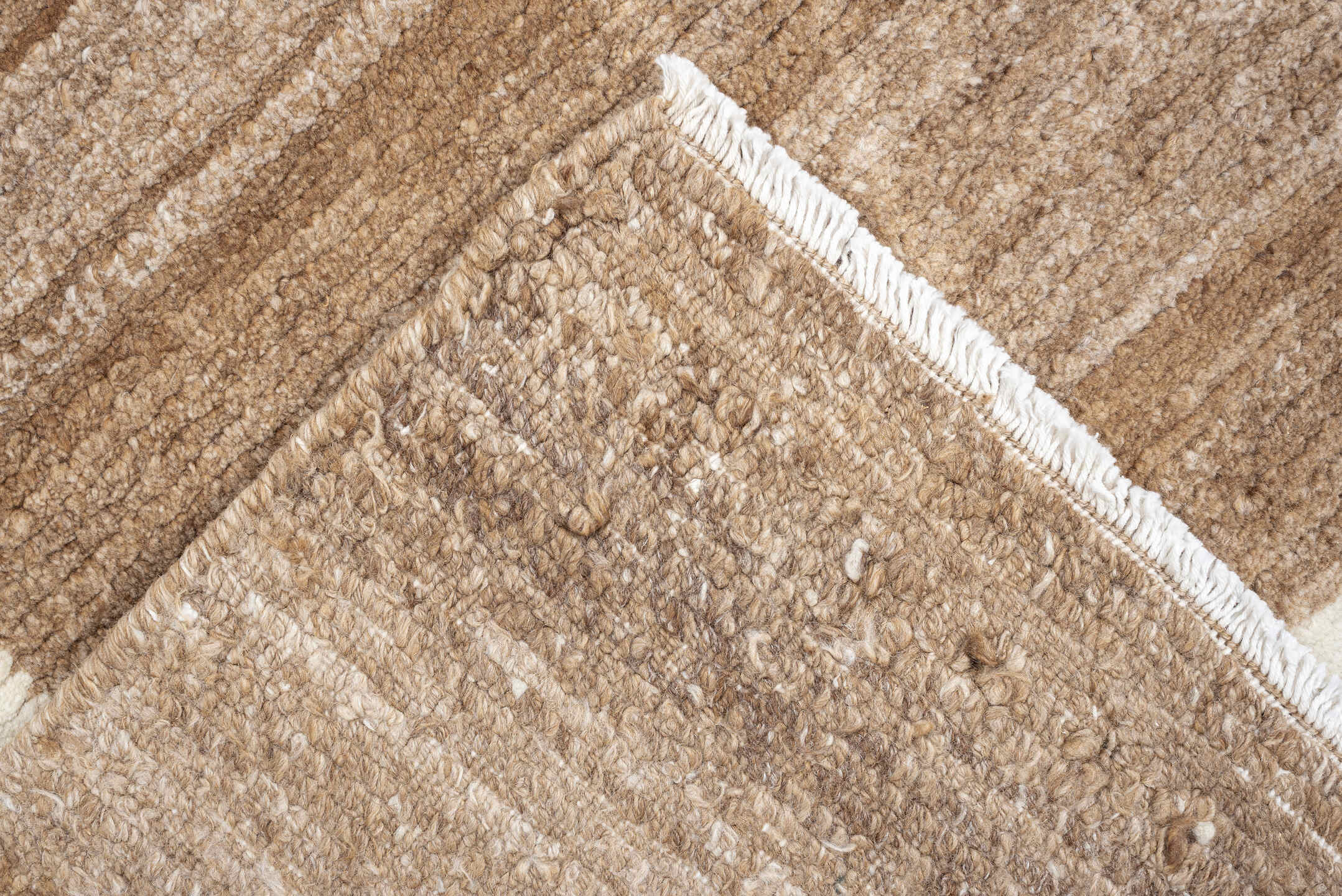 7' x 9' one-of-a-kind handmade vintage Tibetan rug. Color palette: camel, ivory, taupe, beige, cream, gray