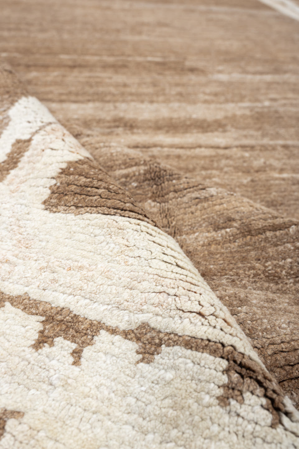 7' x 9' one-of-a-kind handmade vintage Tibetan rug. Color palette: camel, ivory, taupe, beige, cream, gray
