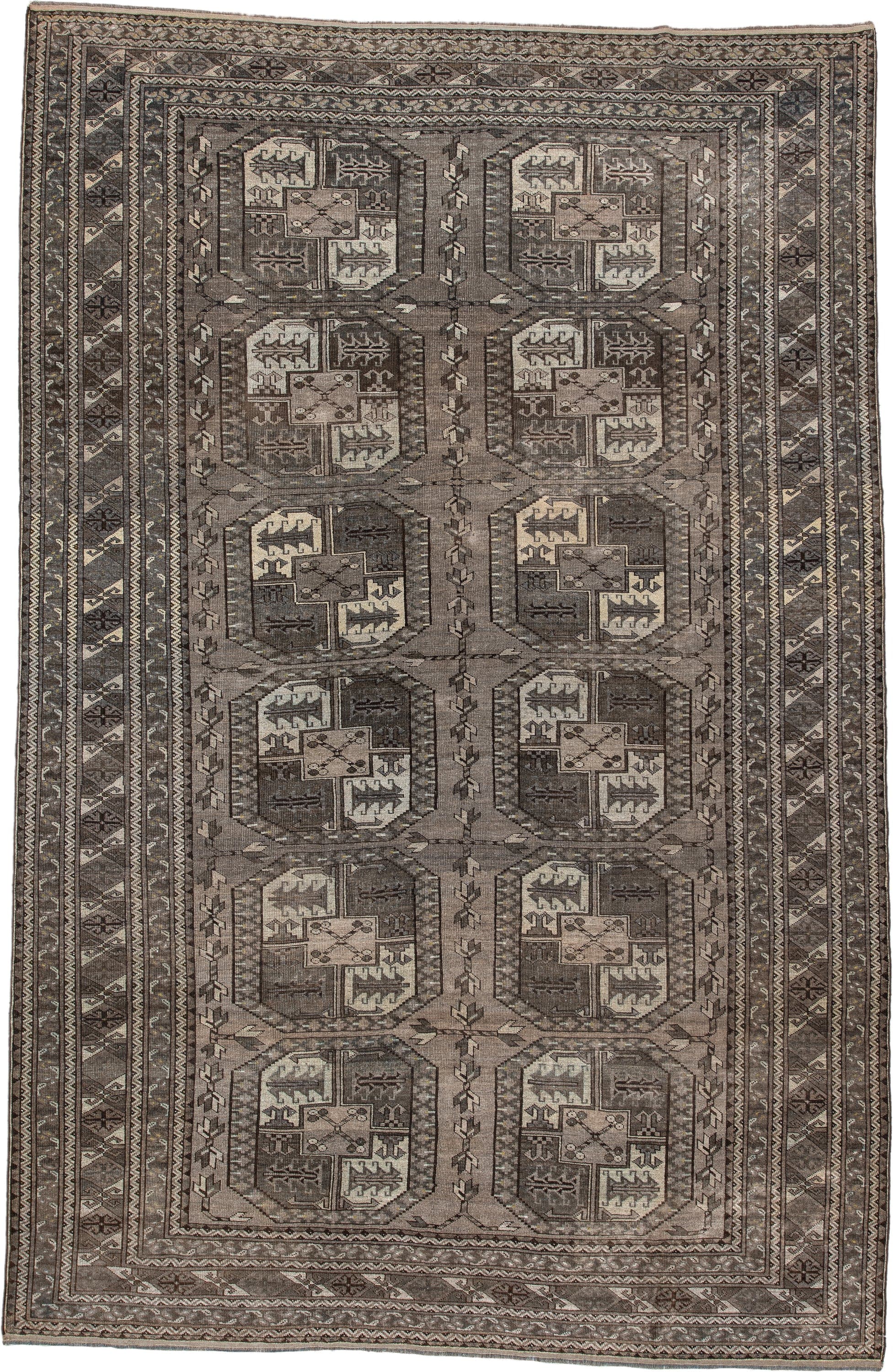 7' x 10' one-of-a-kind handmade antique Afghan large size rug. Color palette: taupe, brown, ivory, charcoal, slate, camel