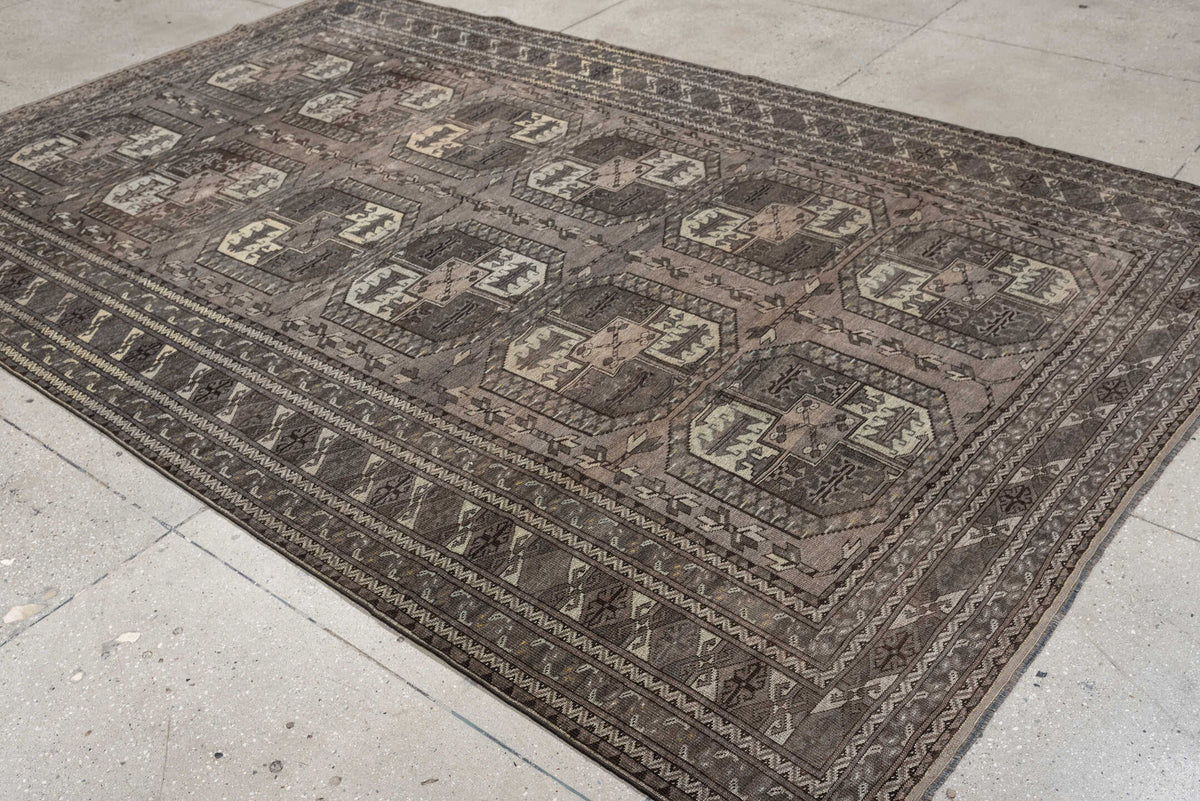7' x 10' one-of-a-kind handmade antique Afghan large size rug. Color palette: taupe, brown, ivory, charcoal, slate, camel