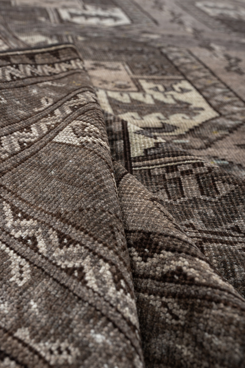 7' x 10' one-of-a-kind handmade antique Afghan large size rug. Color palette: taupe, brown, ivory, charcoal, slate, camel