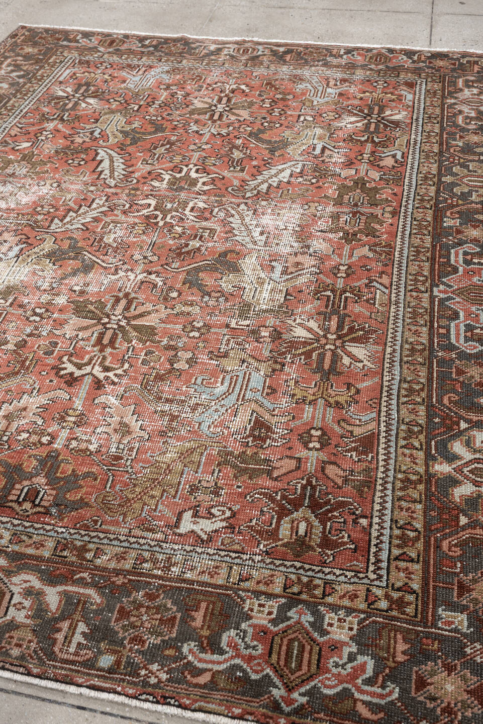 6' x 8' one-of-a-kind handmade antique Heriz rug. Color palette: terracotta, charcoal, ivory, rust, olive, light blue, camel