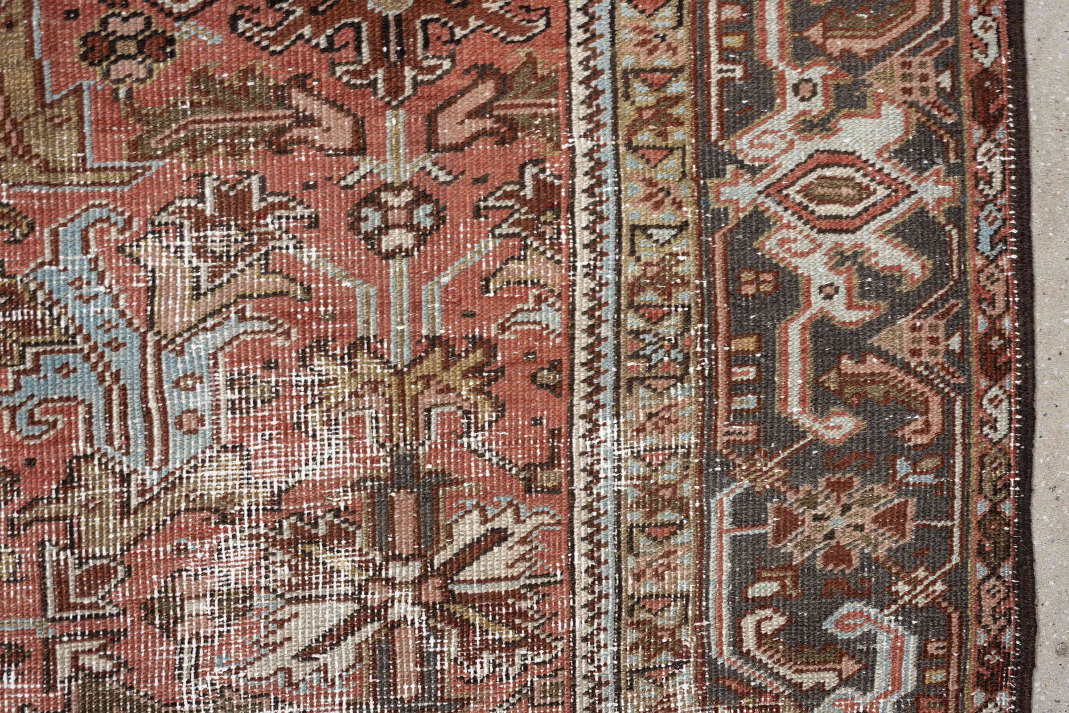 6' x 8' one-of-a-kind handmade antique Heriz rug. Color palette: terracotta, charcoal, ivory, rust, olive, light blue, camel